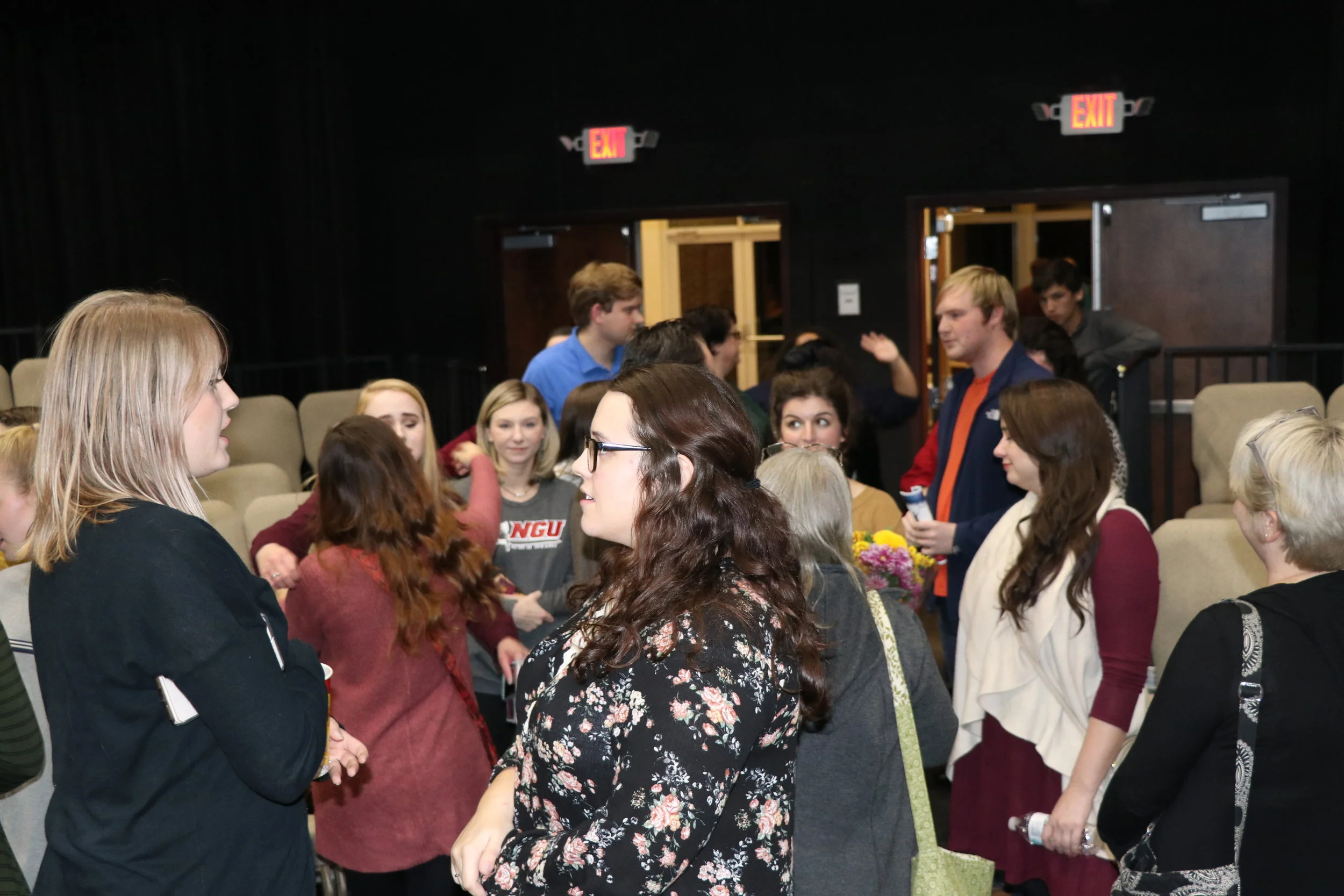Friends and family gather around to congratulate their loved ones who were in the play.