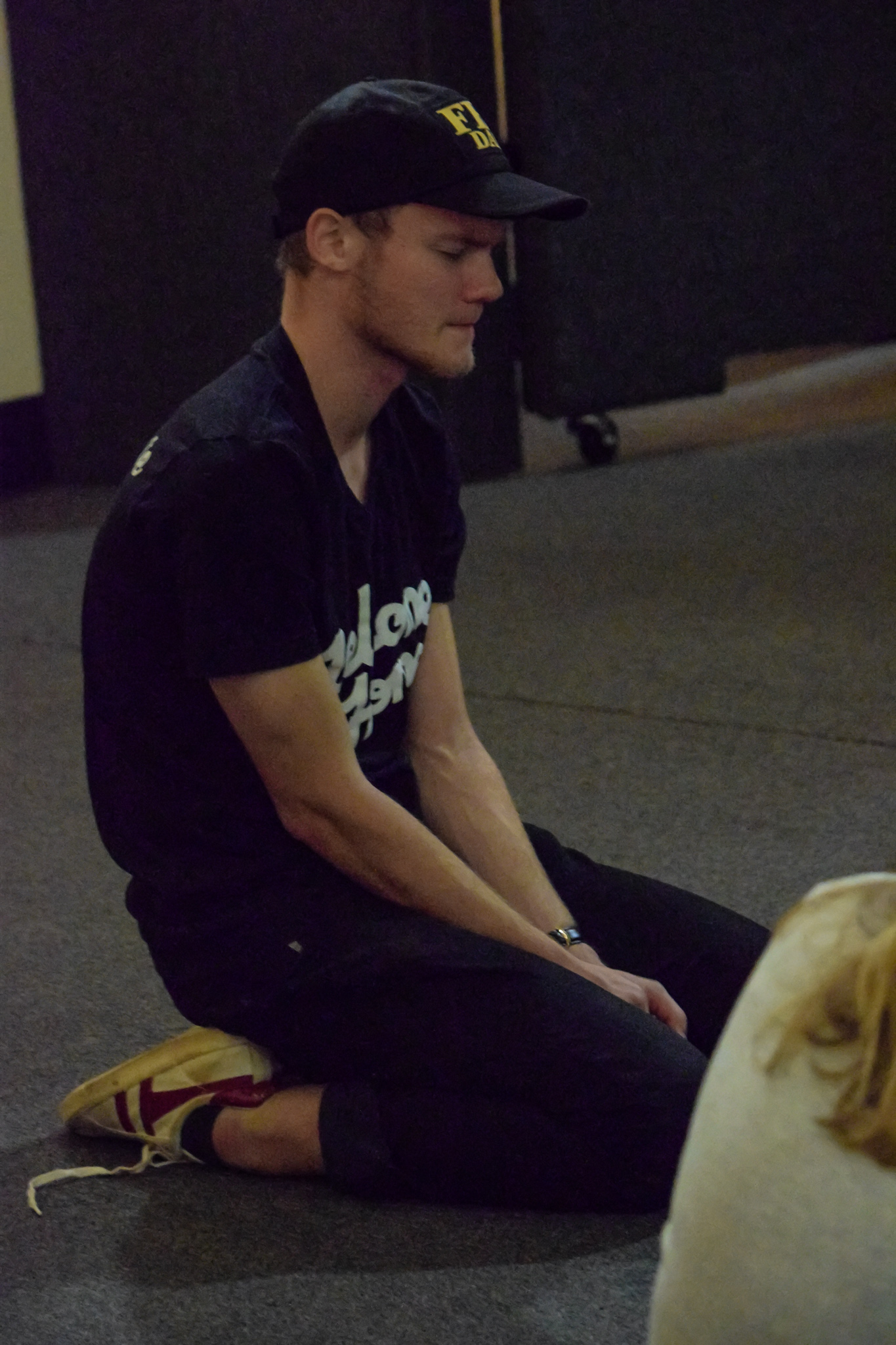 Kesey thinks over what to say as he prays for the university.