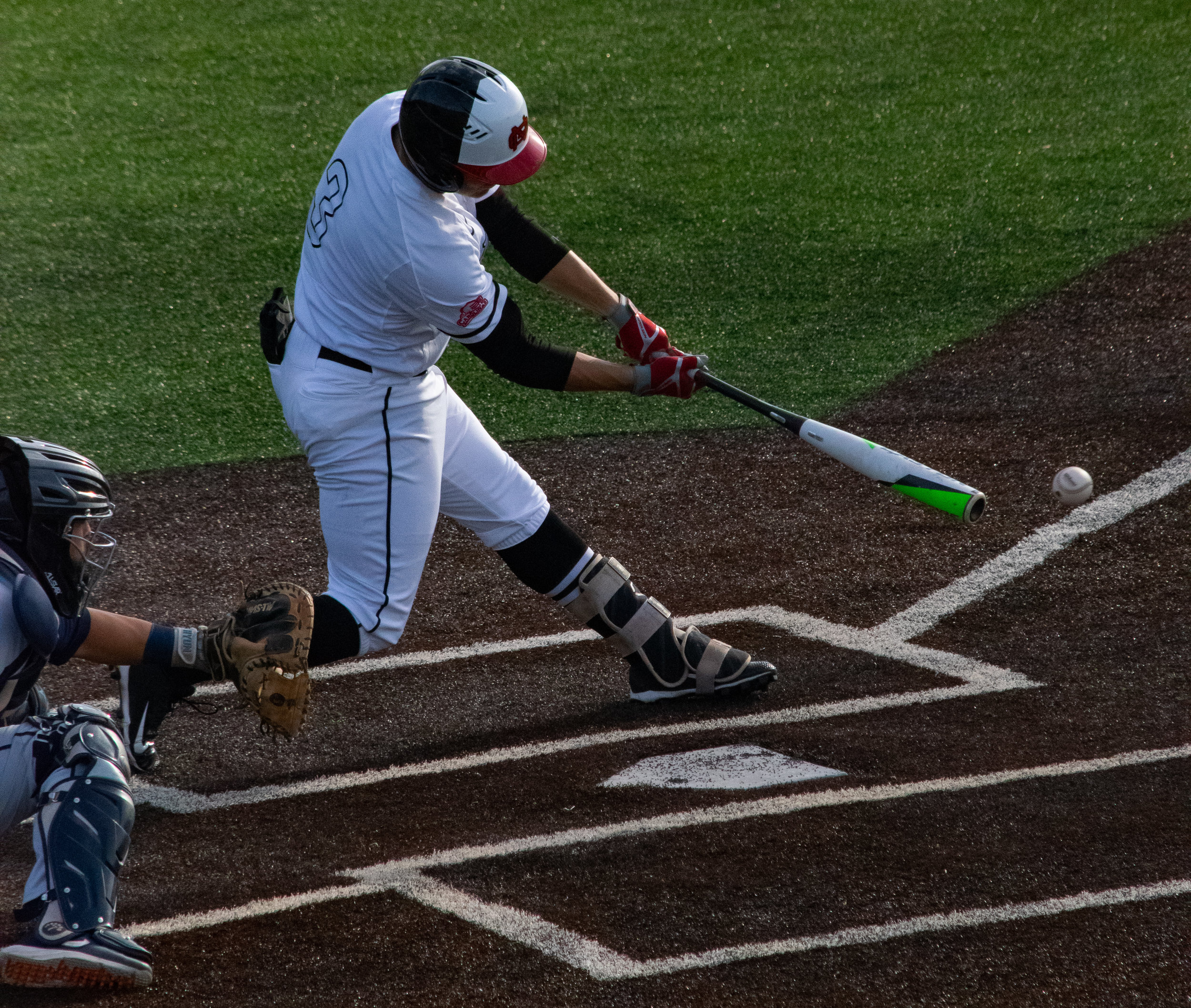 Senior Jack Morris (3) swings low to tip the ball to left field.