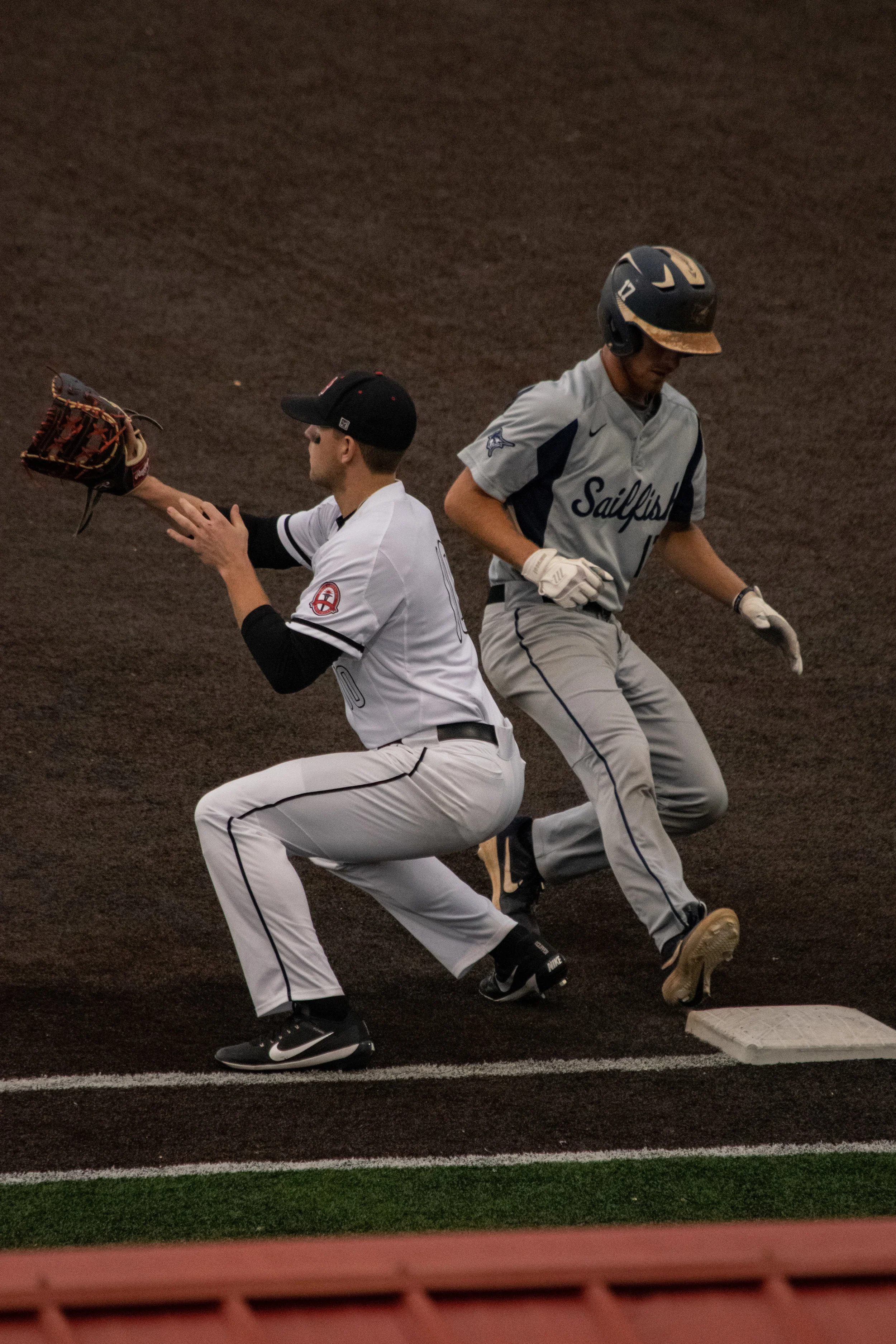 Sasser (10) waits to catch the ball from the pitcher to prevent his opponent from stealing second base.