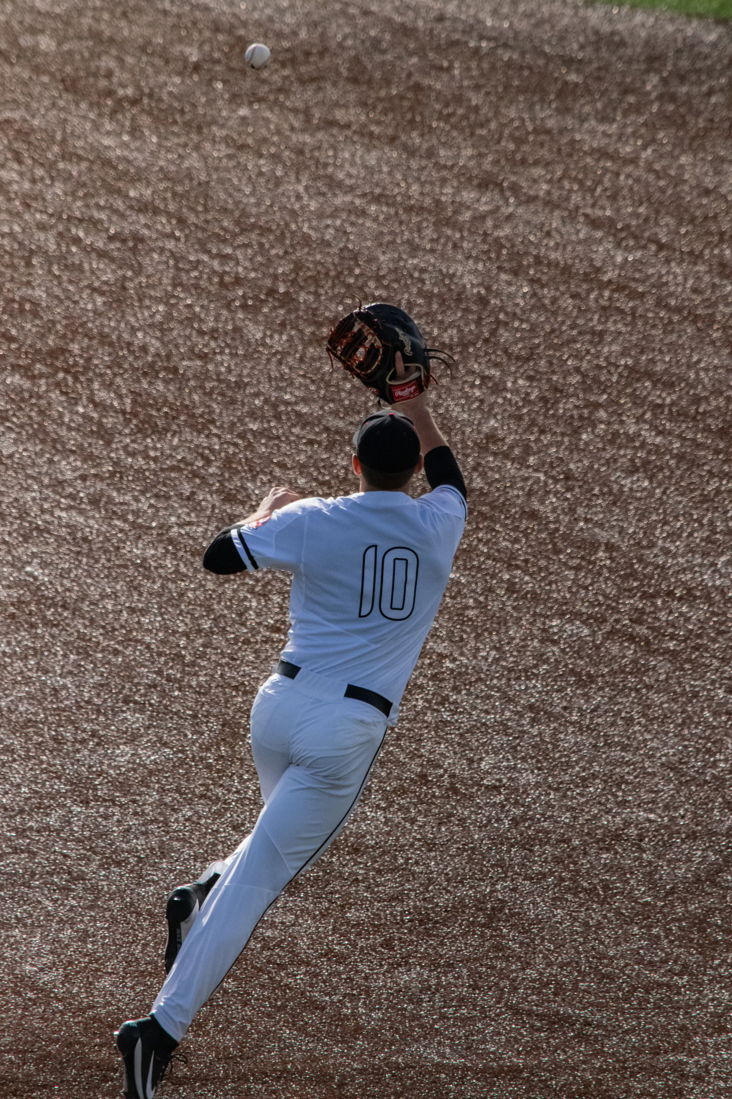 Sasser (10) jumps to catch the ball to keep the runners from advancing.