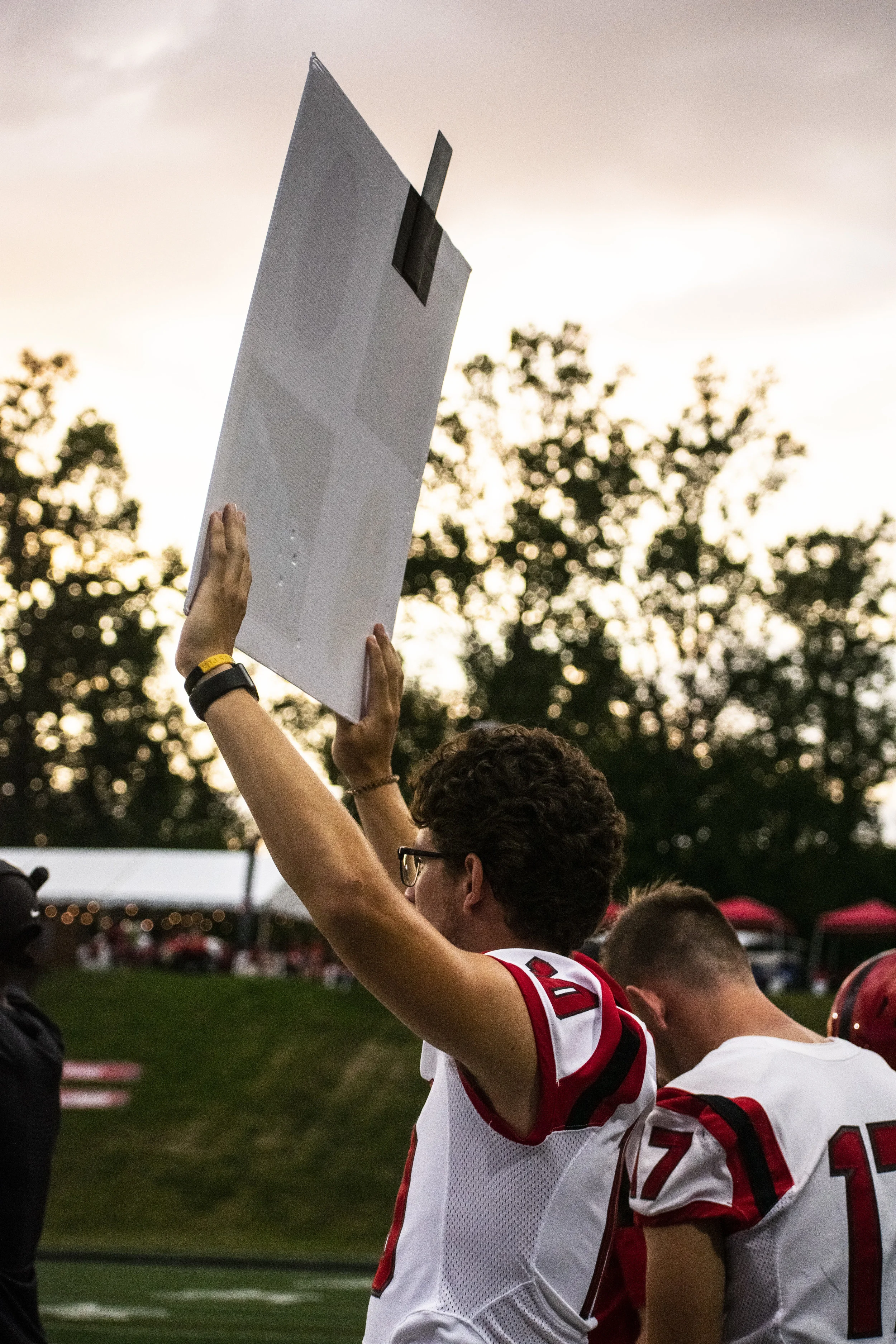 Freshman Eric Tuttle (18) shows the team what play to do.
