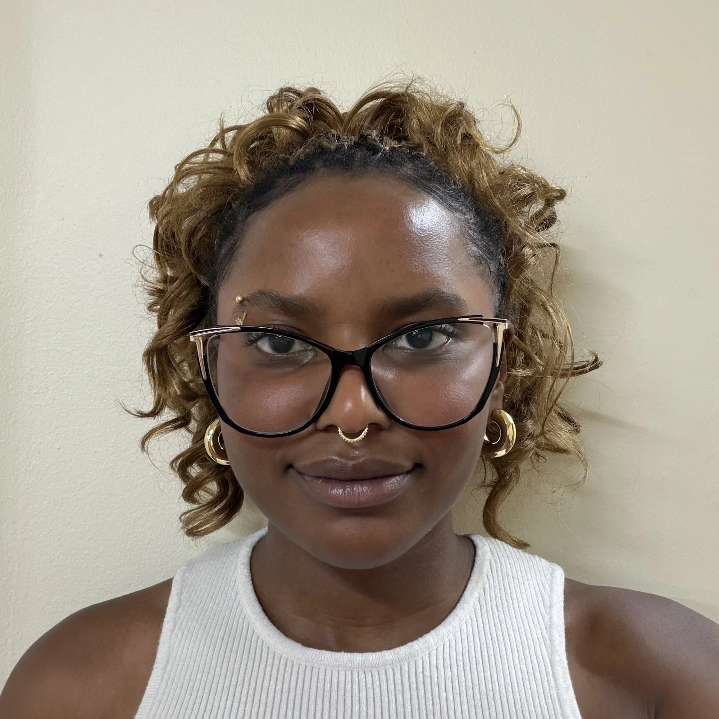 Young woman with white tank top and glasses