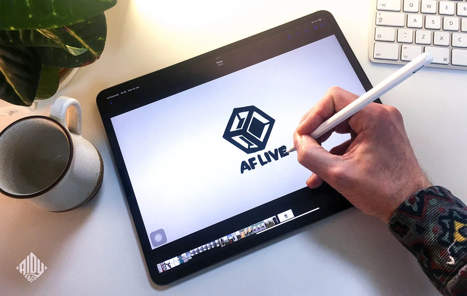 A close up shot of a designer sketching on an ipad in a studio setting