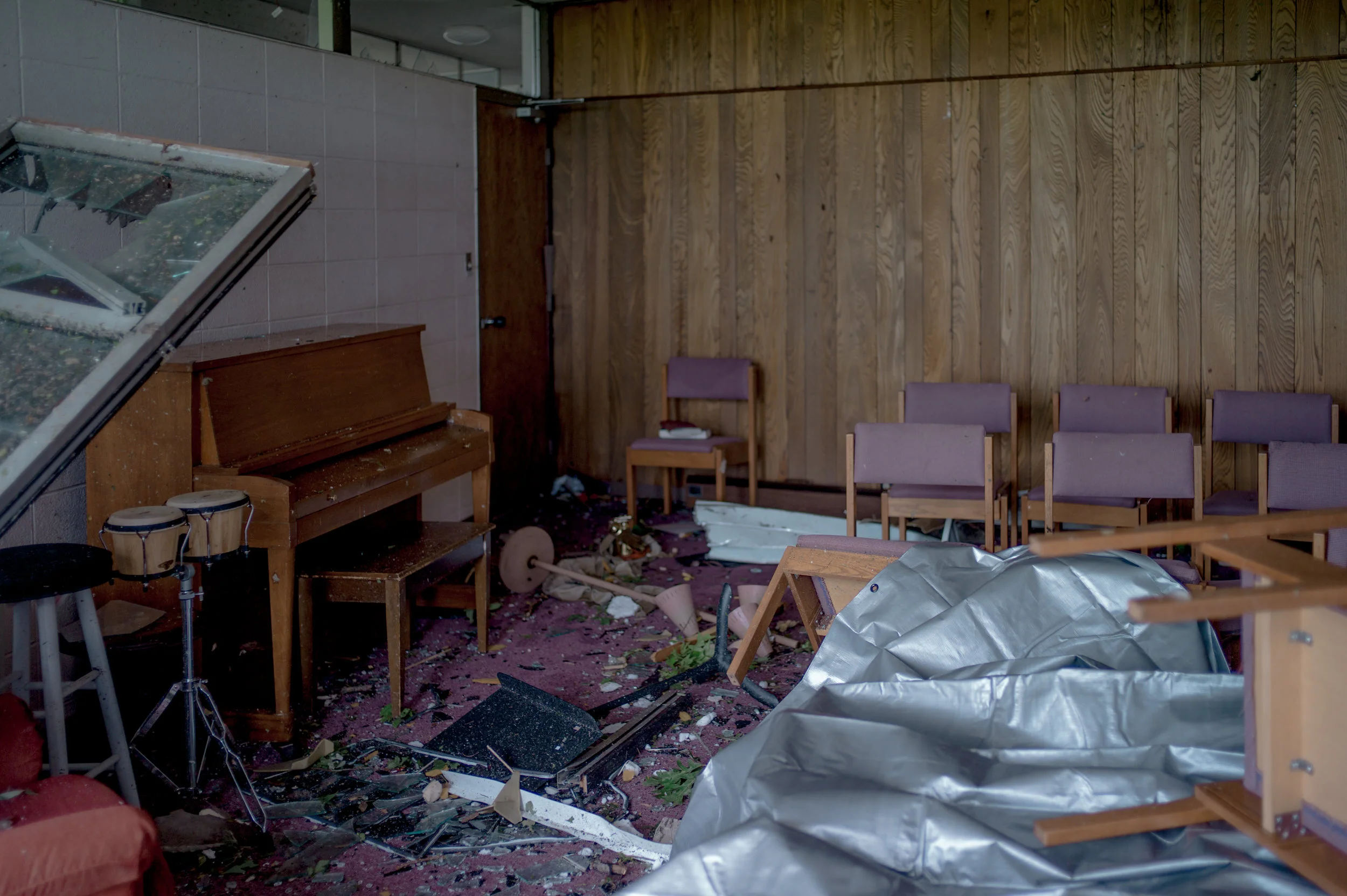 Shattered windows reveal religious artifacts scattered around the Community Christian Church on Ellis Boulevard on May 23, 2019 in Jefferson City.