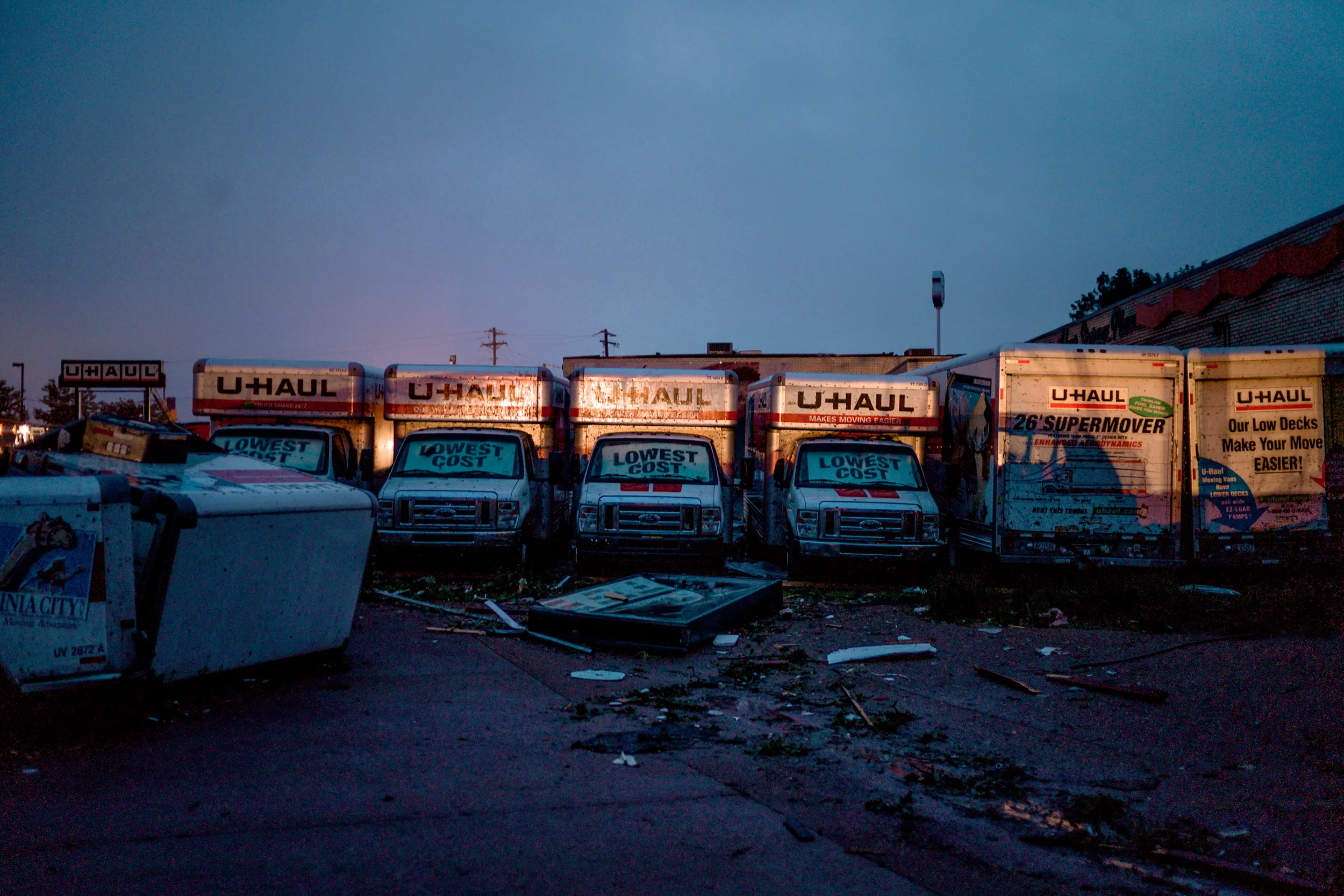 U HUAL trucks are illuminated by service vehicles removing debris off of Ellis Boulevard on May 23, 2019 in Jefferson City.