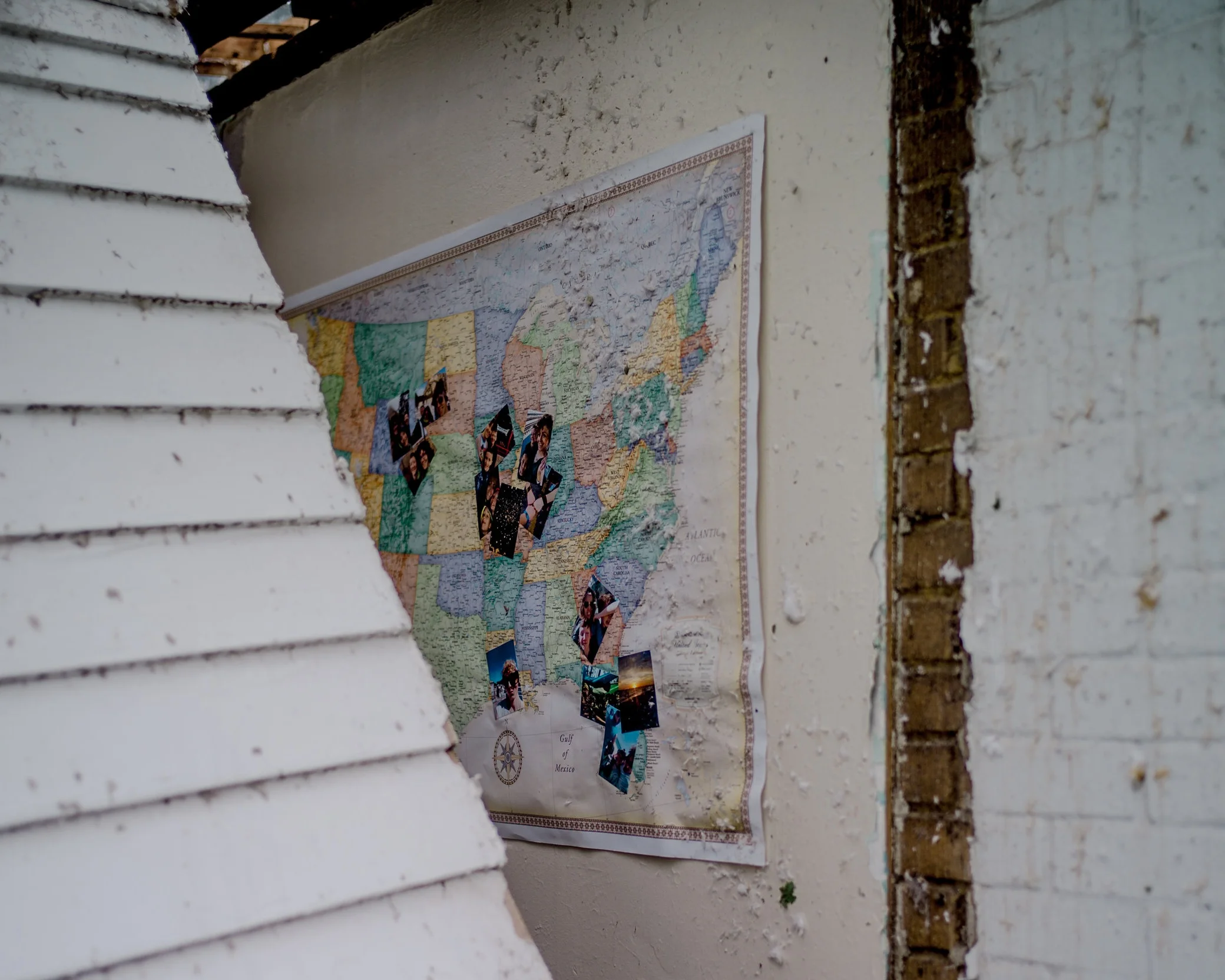 A fallen laundry room wall reveals family photos on Jackson Street on May 23, 2019 in Jefferson City.