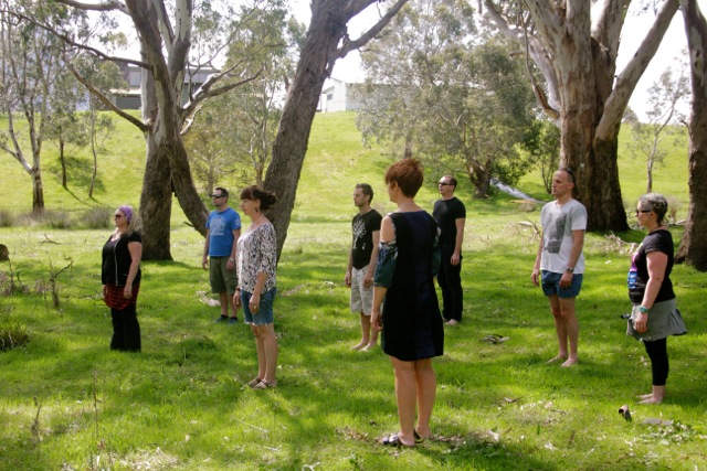 Students enjoying the serenity and inner peace in standing meditation during a guided relaxation class.