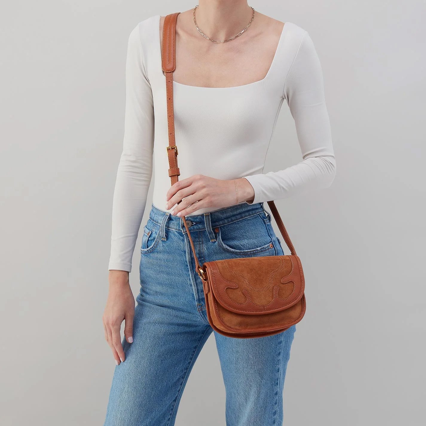 The kiva small crossbody handbag by Hobo in oak barrel colored leather