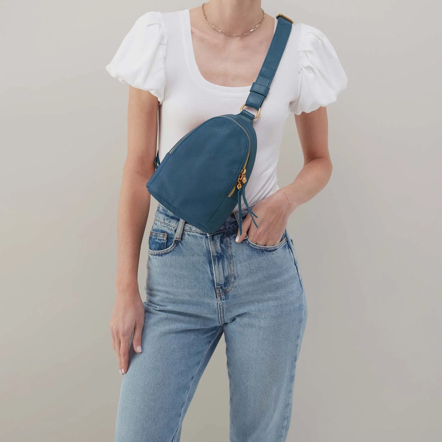The fern sling bag by Hobo in peacock feather colored leather