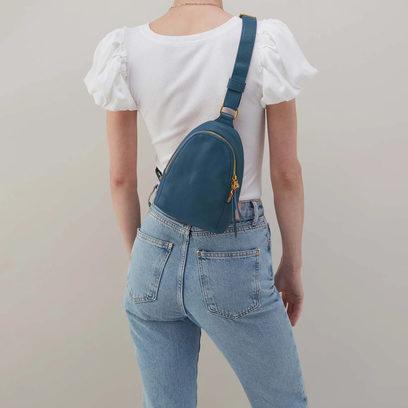 The fern sling bag by Hobo in peacock feather colored leather