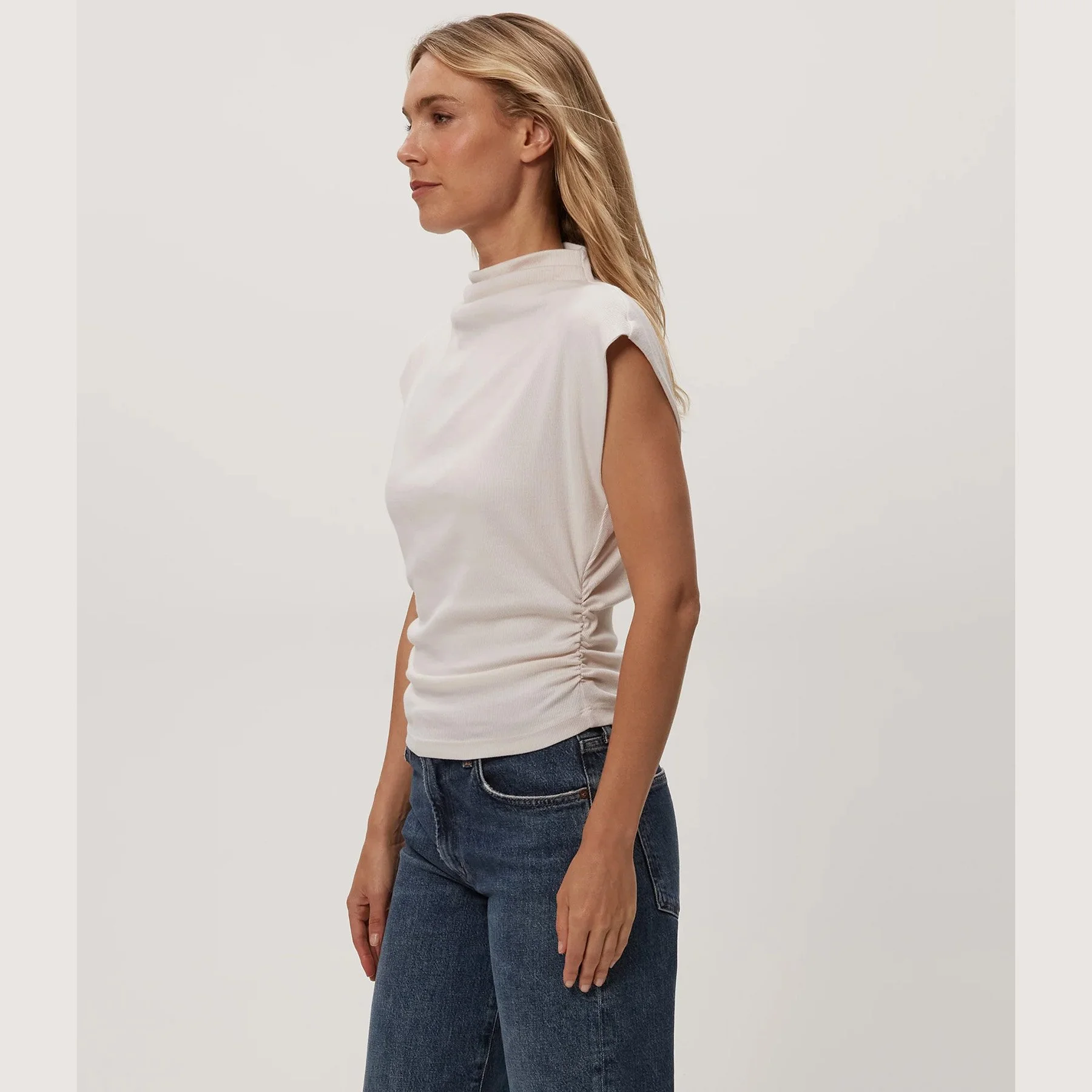 The amara mock neck power shoulder top by Michael Stars in chalk color
