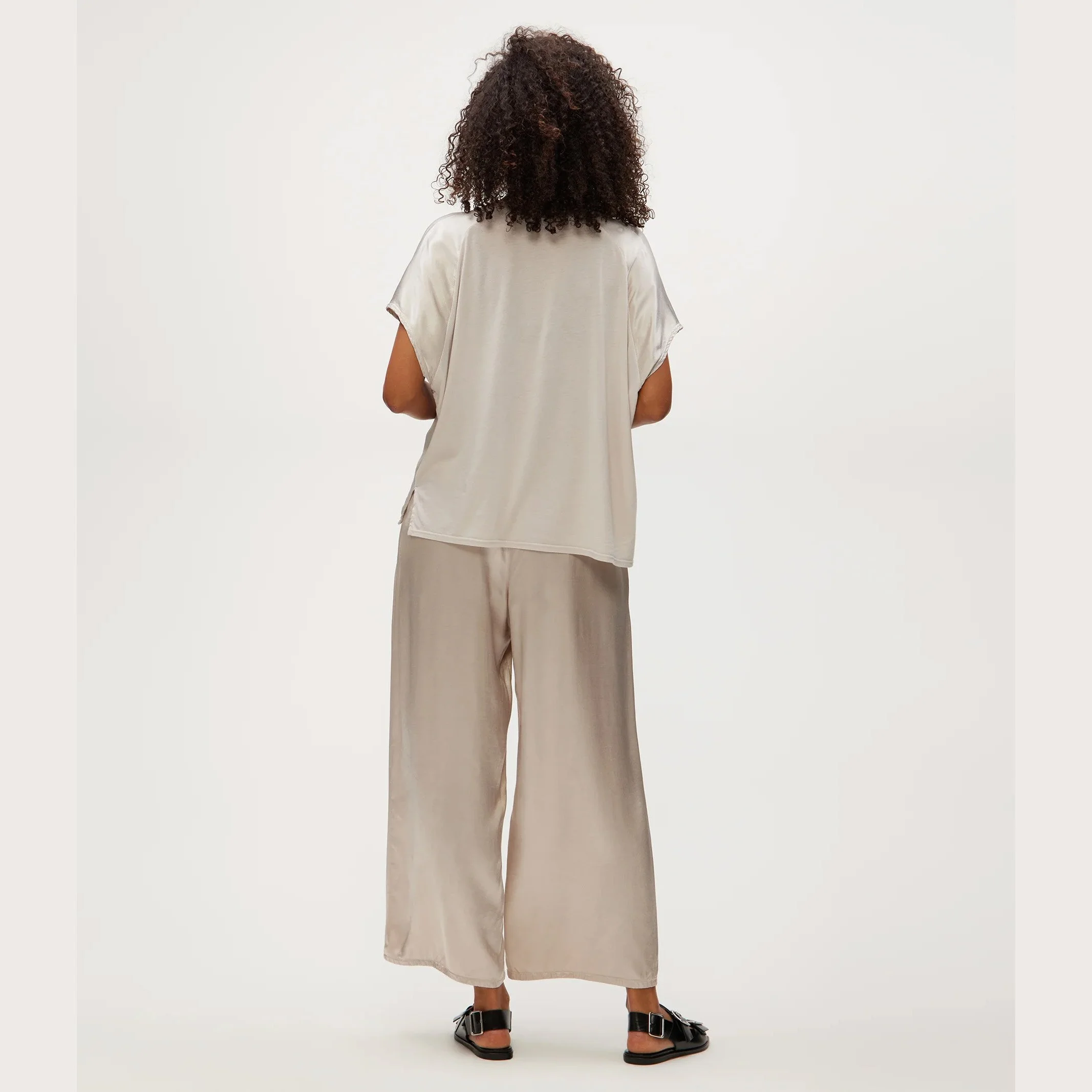 The sacha satin cropped pant by Michael Stars, in cement color, rear view.