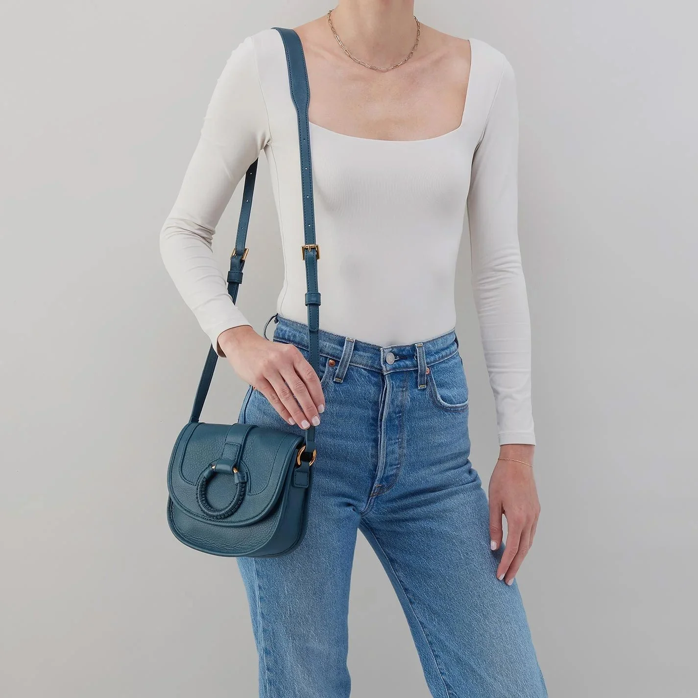 The kiva small crossbody handbag by Hobo in peacock feather colored leather