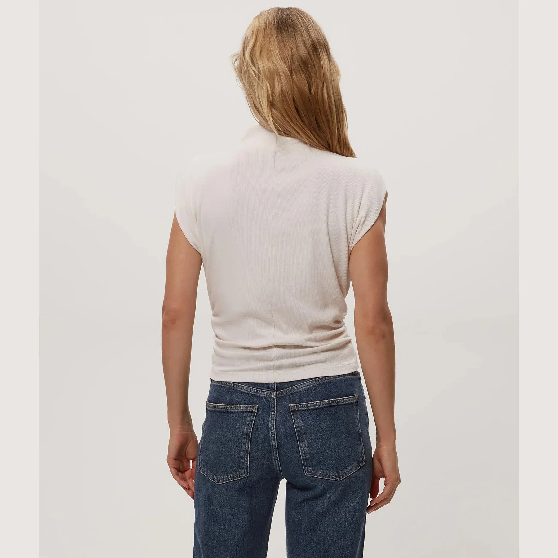 The amara mock neck power shoulder top by Michael Stars in chalk color