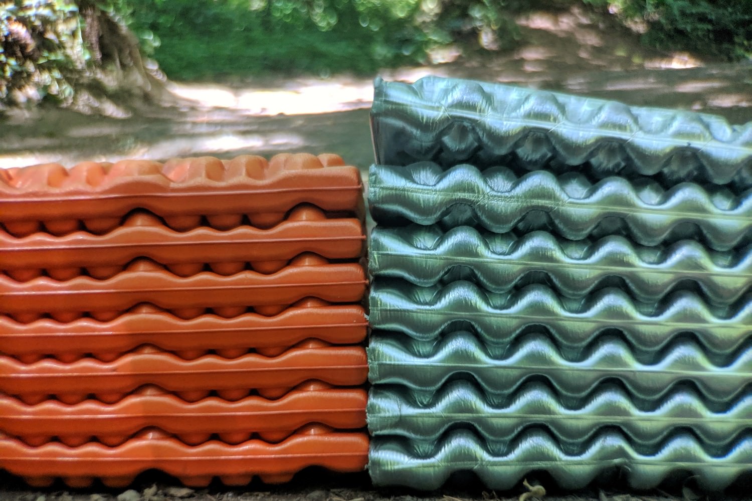The Switchback (left) packs down roughly an inch smaller than the Z Lite sol.