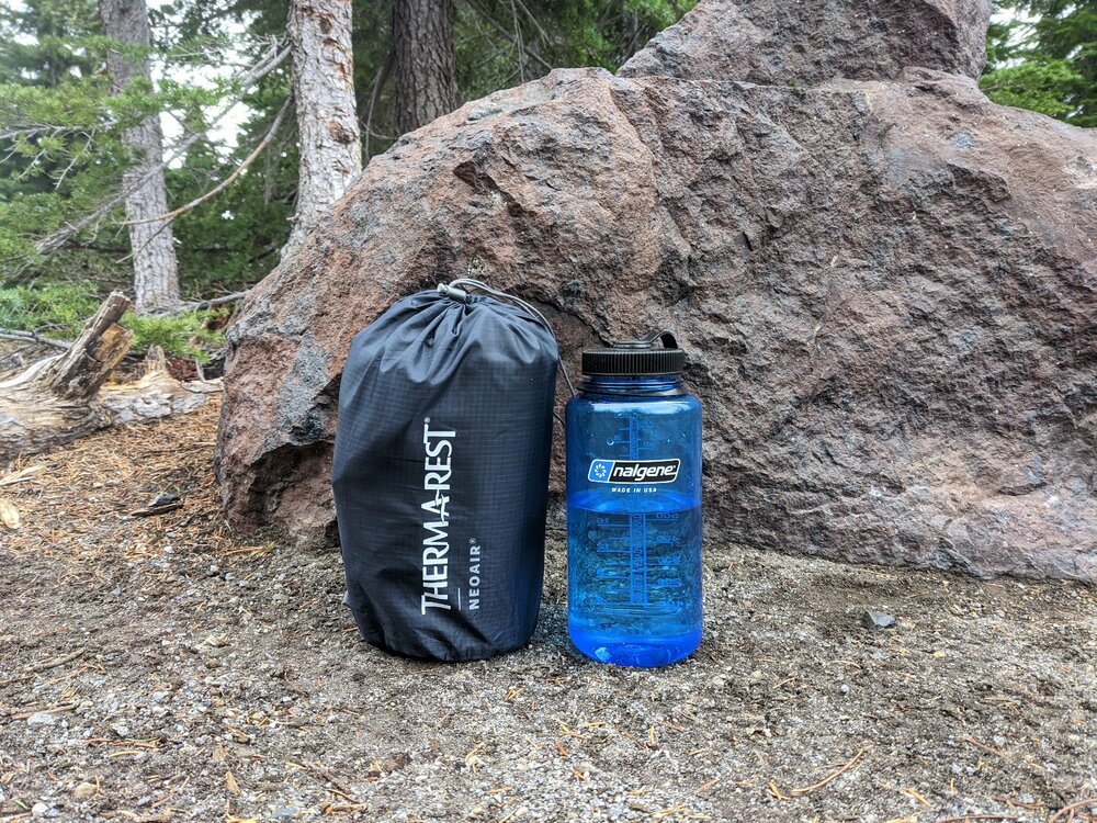 Comparing the packed size of the XTherm to a 32 oz. Nalgene water bottle.