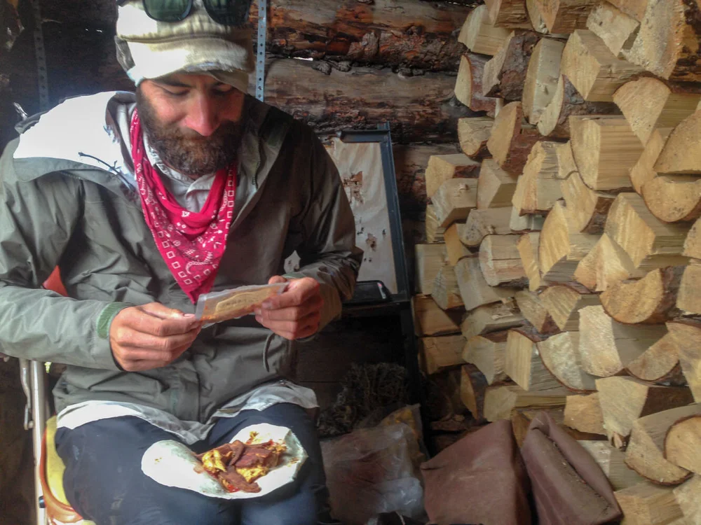 A hiker eating the Backpacker Elvis wrap.