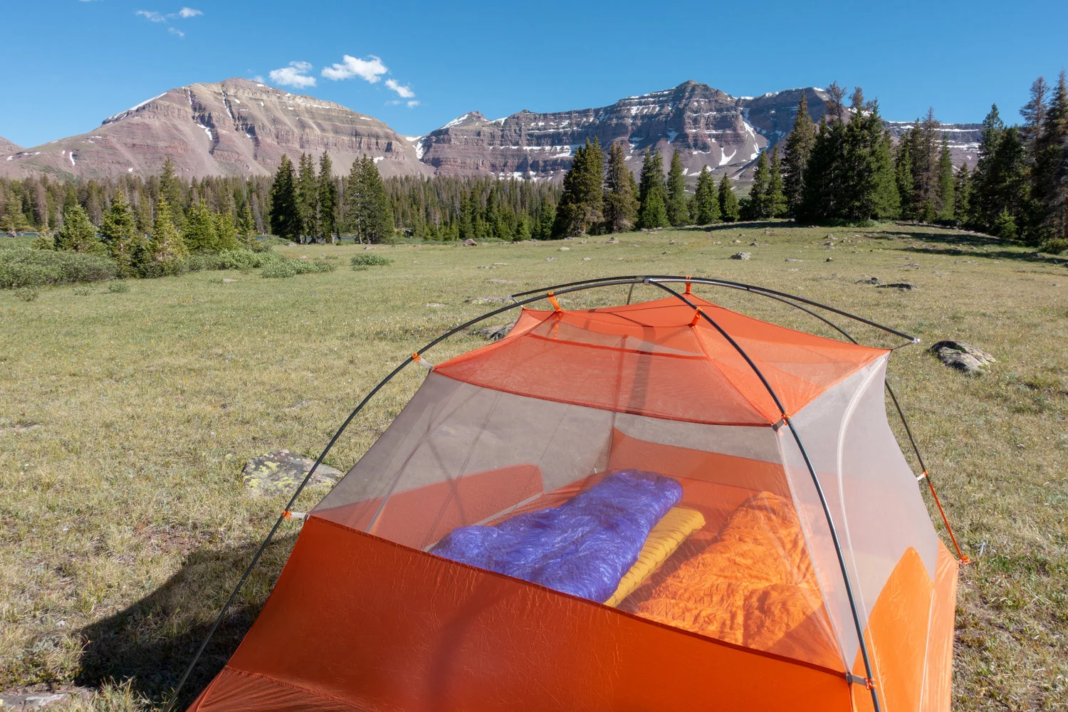 The Western Mountaineering UltraLite (left) and Feathered Friends Flicker Quilt are great options for backpackers looking to keep weight to a minimum without sacrificing warmth.