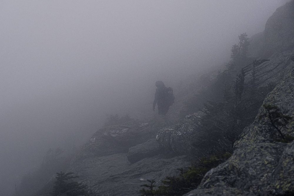 A very foggy scene with a Long Trail hiker on the Long Trail