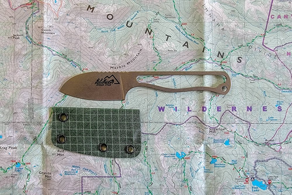 The ULA Alpha Knife and its sheath on top of a topo map