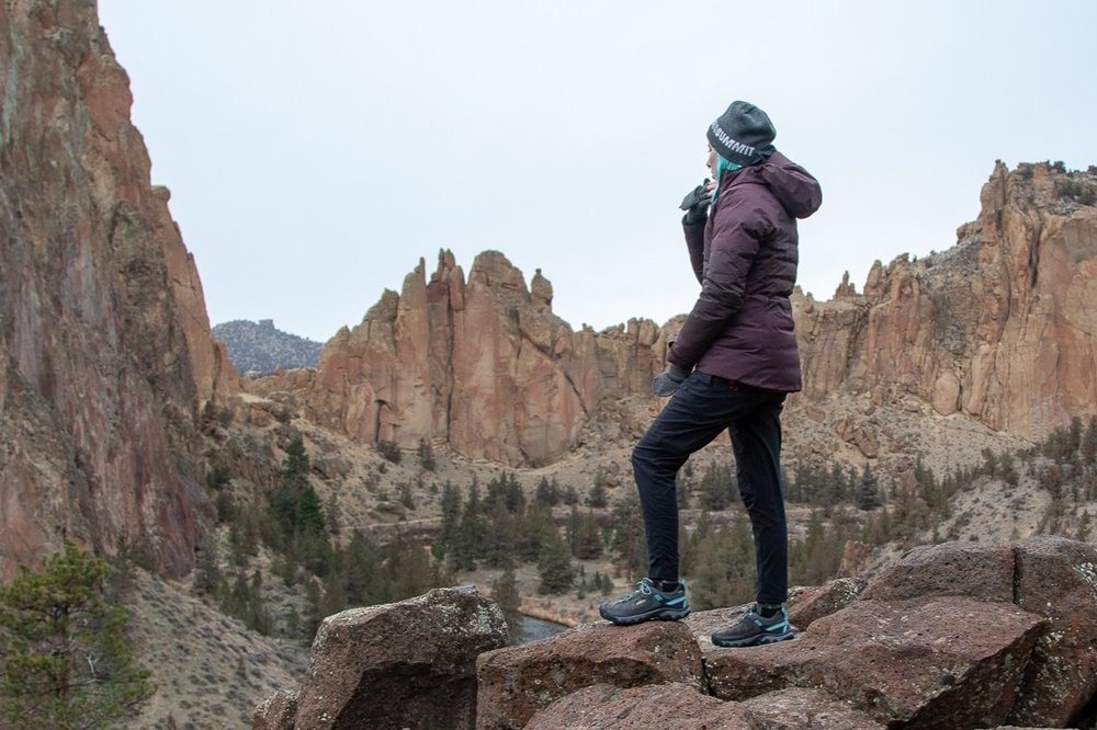 A hiker wearing an REI Stormhenge Jacket looking at a mountain view