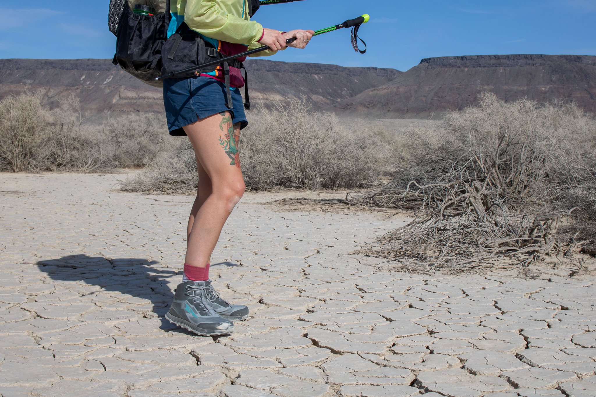 A backpacker wearing the Altra Lone Peak All-WTHR Mid Boots on a desert hike