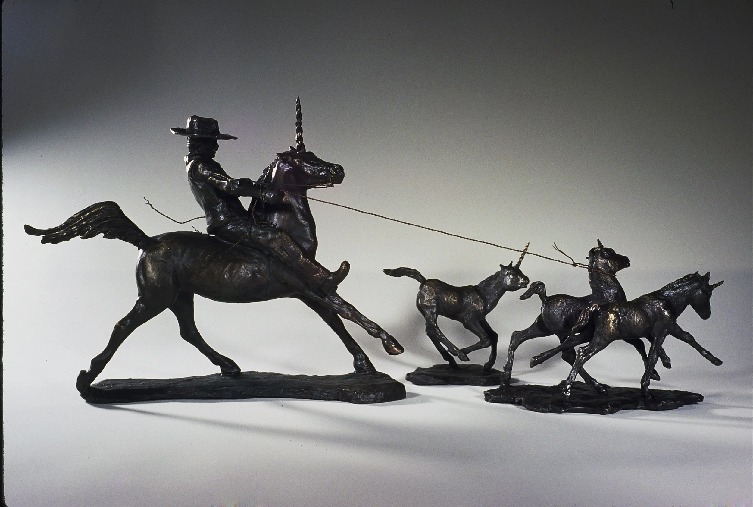Cowboy and Baby Unicorns, bronze, 12" x 20" x 6", 1997