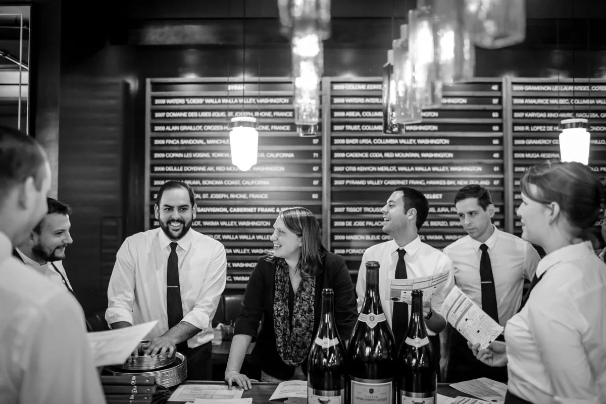 Executive Chef David Varley (far left) shares a laugh with his FOH staff during their pre-service meeting (RN74, Seattle, WA).
