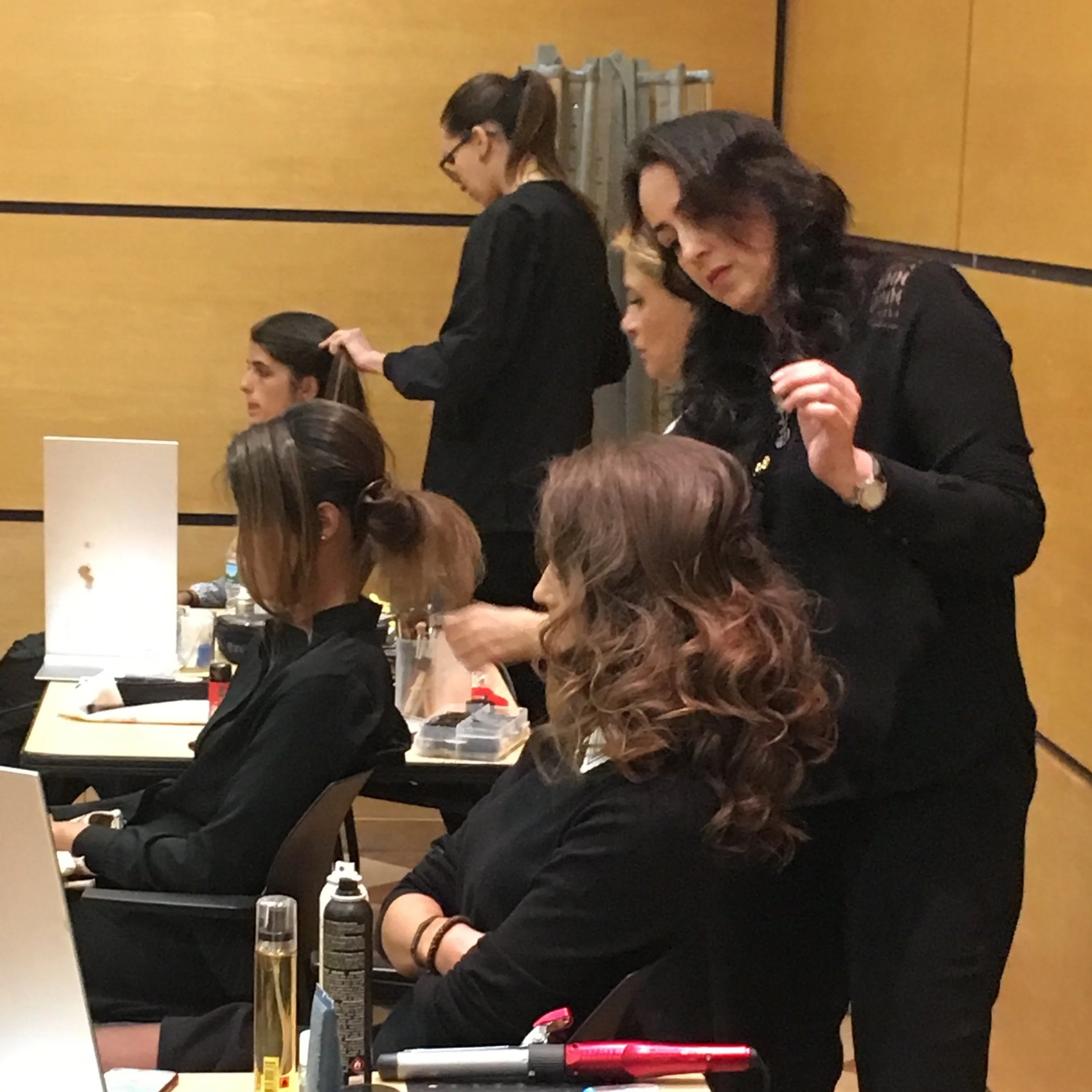 Styling hair at a Colombia MBA event