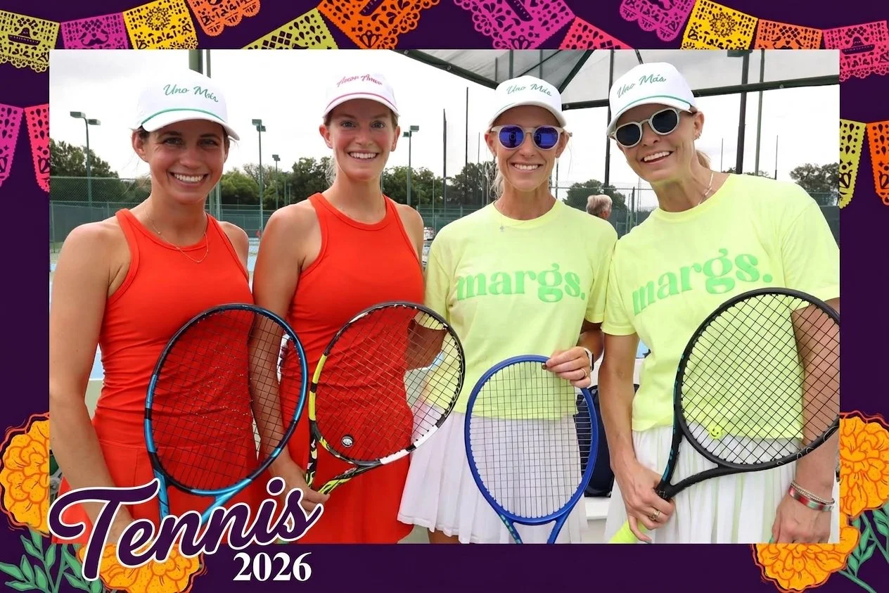 Four players hold their rackets on an outdoor tennis court in a roaming photo booth photo, finished with a custom event frame built for the theme.