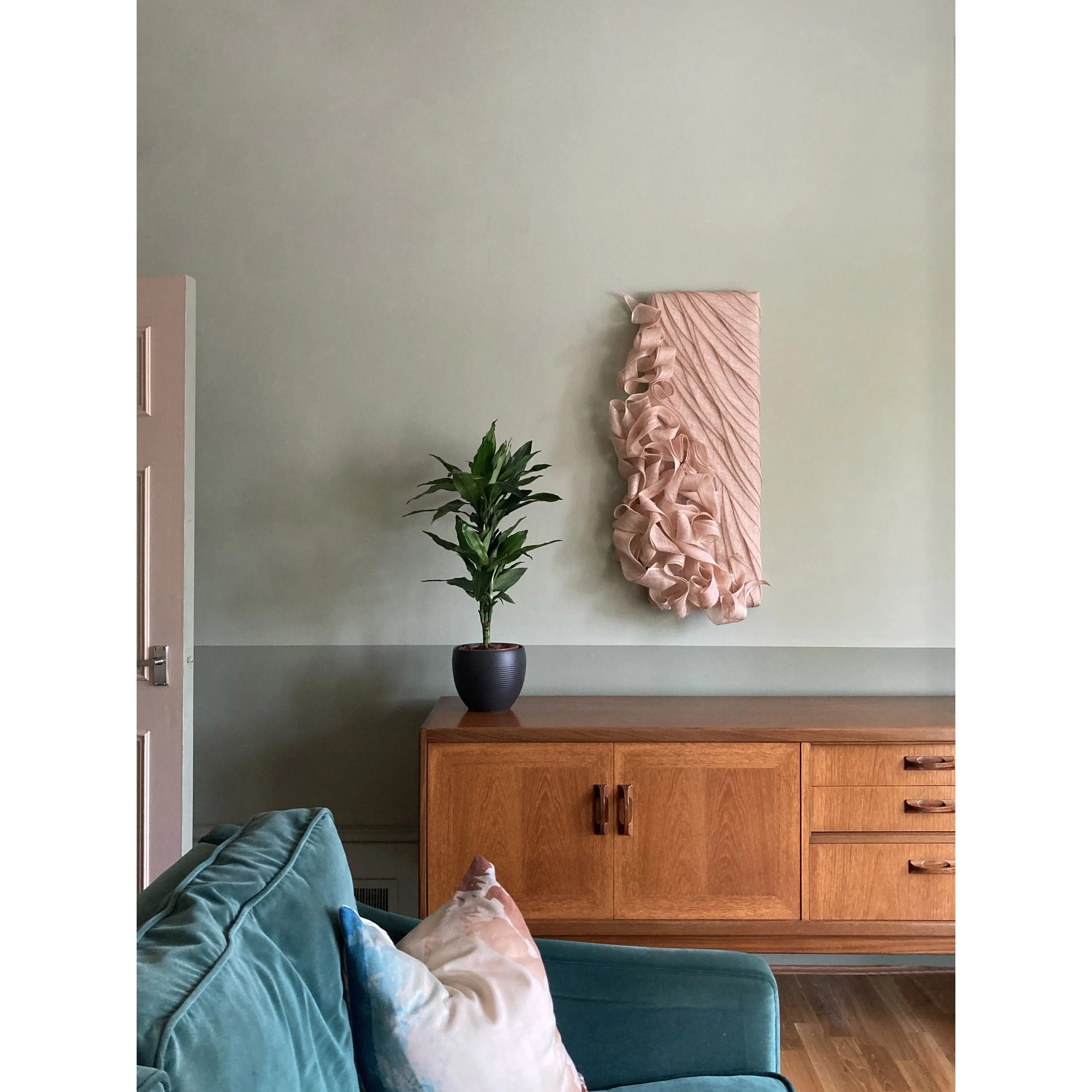Handmade Wall Sculpture by Karen Henriksen: 'Abundance' No. 2 in pink abaca with sideboard and sofa