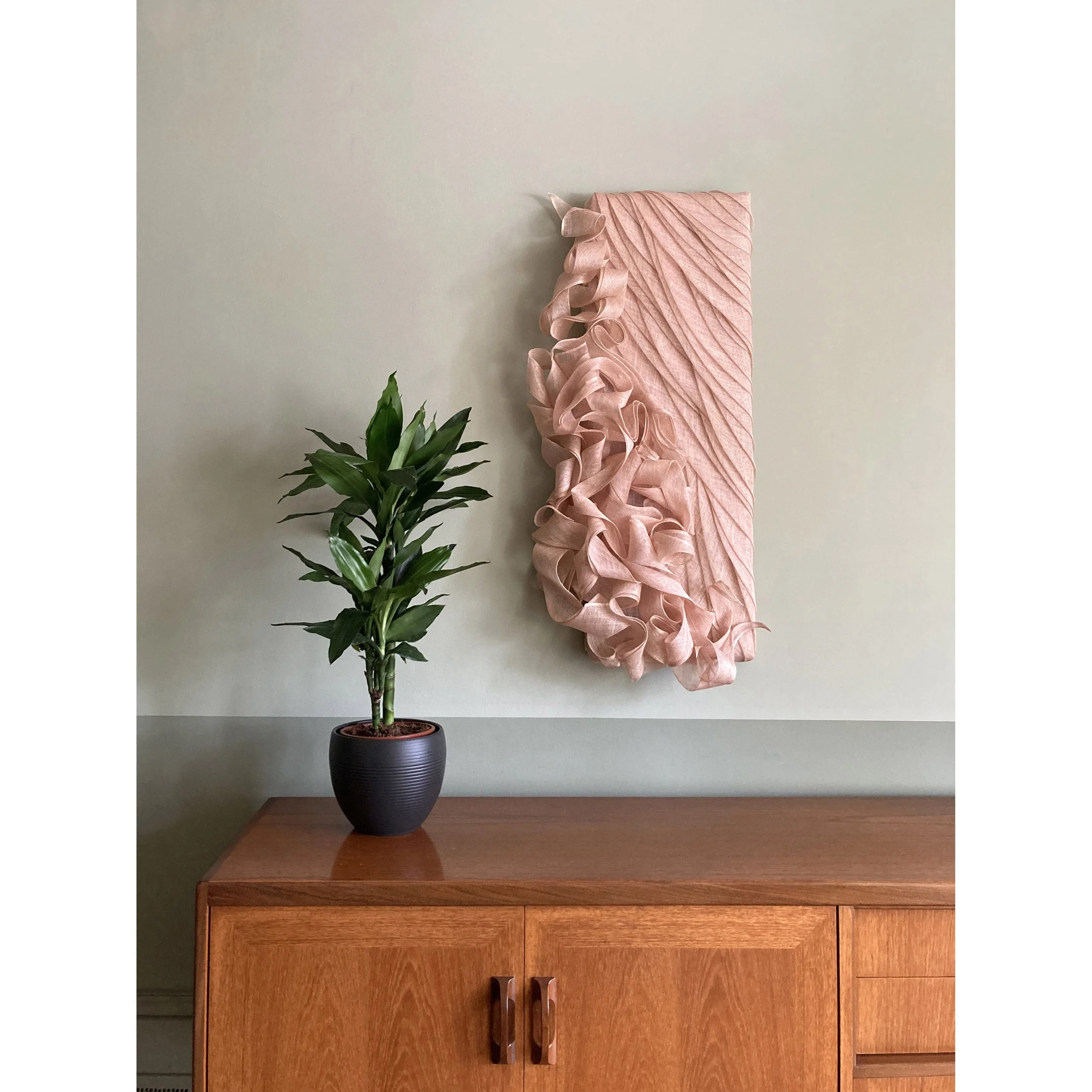 Handmade Wall Sculpture by Karen Henriksen: 'Abundance' No. 2 in pink abaca with midcentury sideboard