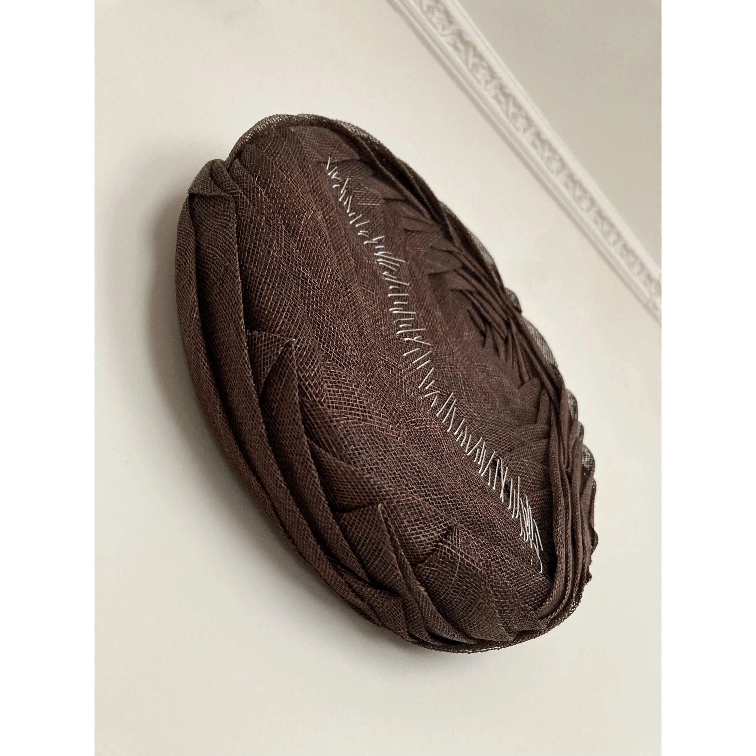 Handmade Wall Sculpture by Karen Henriksen: 'Digression' No. 2 in dark brown abaca with silver stitch detail, seen from below