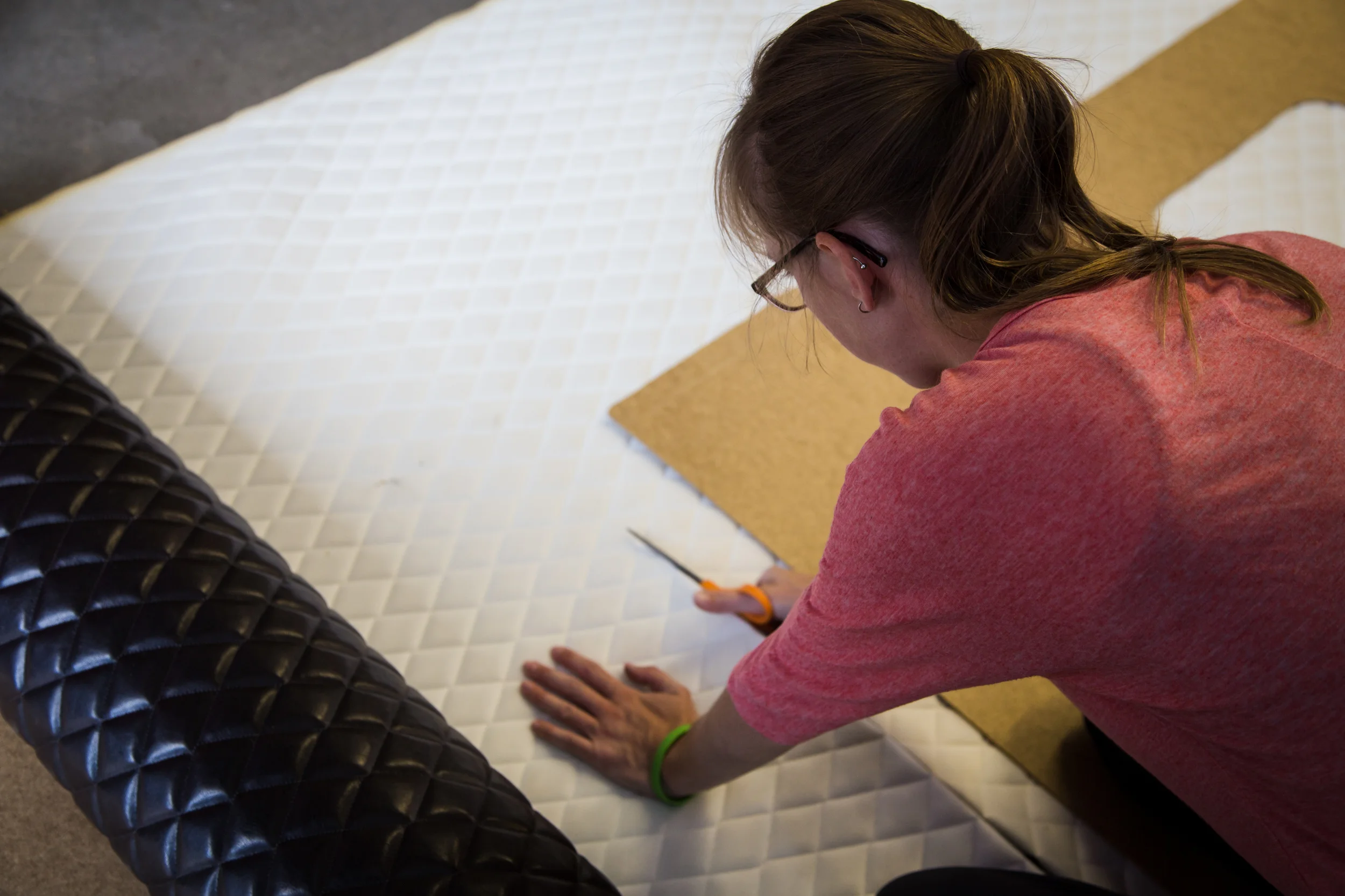 Cutting foam-backed vinyl upholstery for the new door pads.