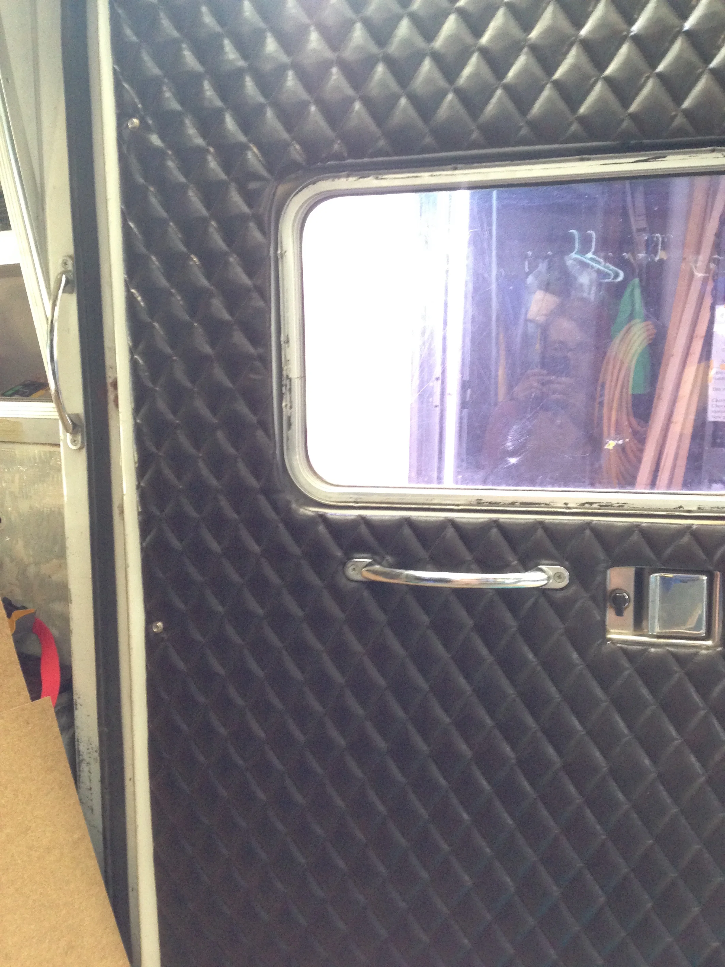 Here you can see the new vinyl quilted upholstery I put on the doors in place of the old grey padding that was there before.