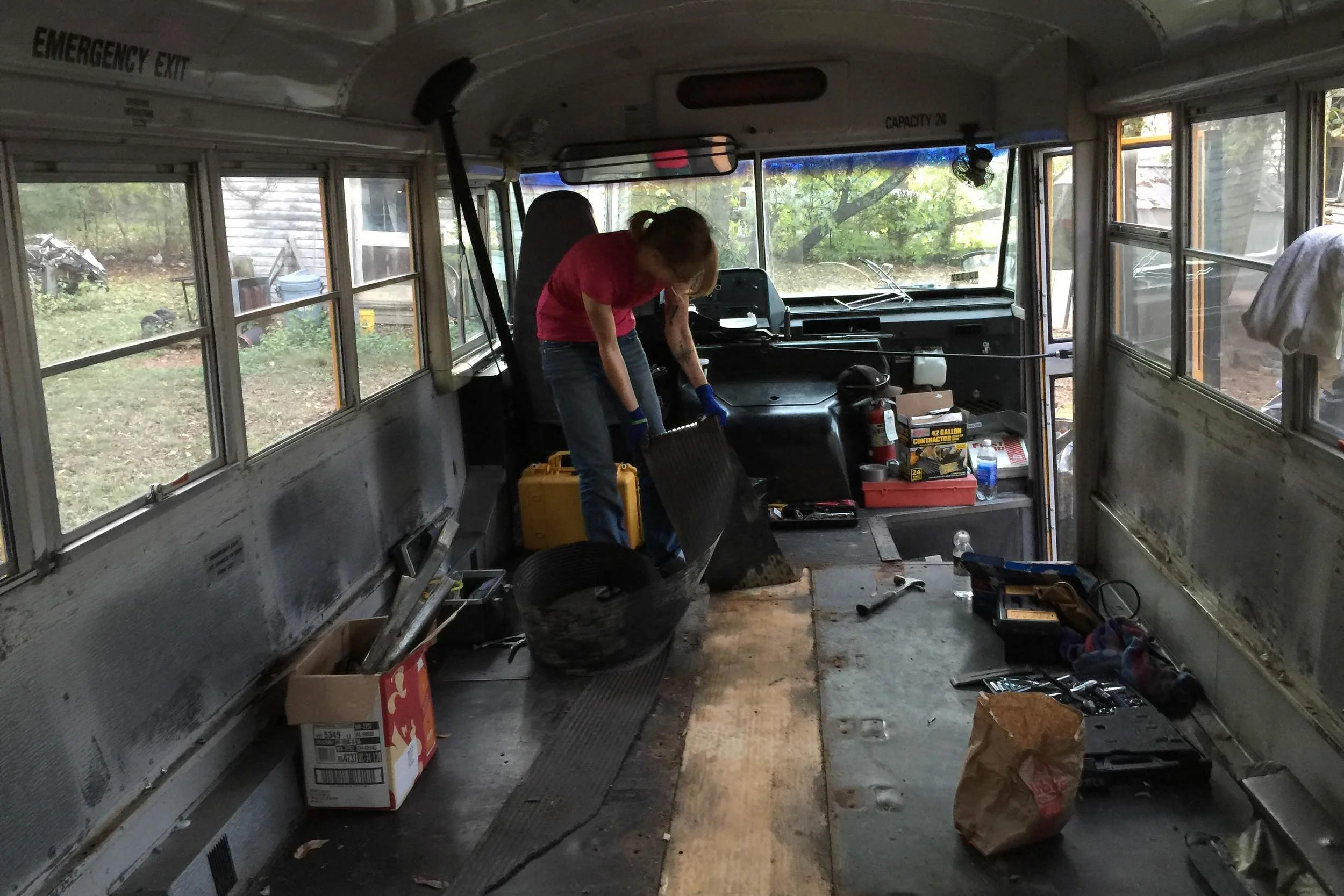 Pulling up the aisle vinyl to check out the wood underneath.