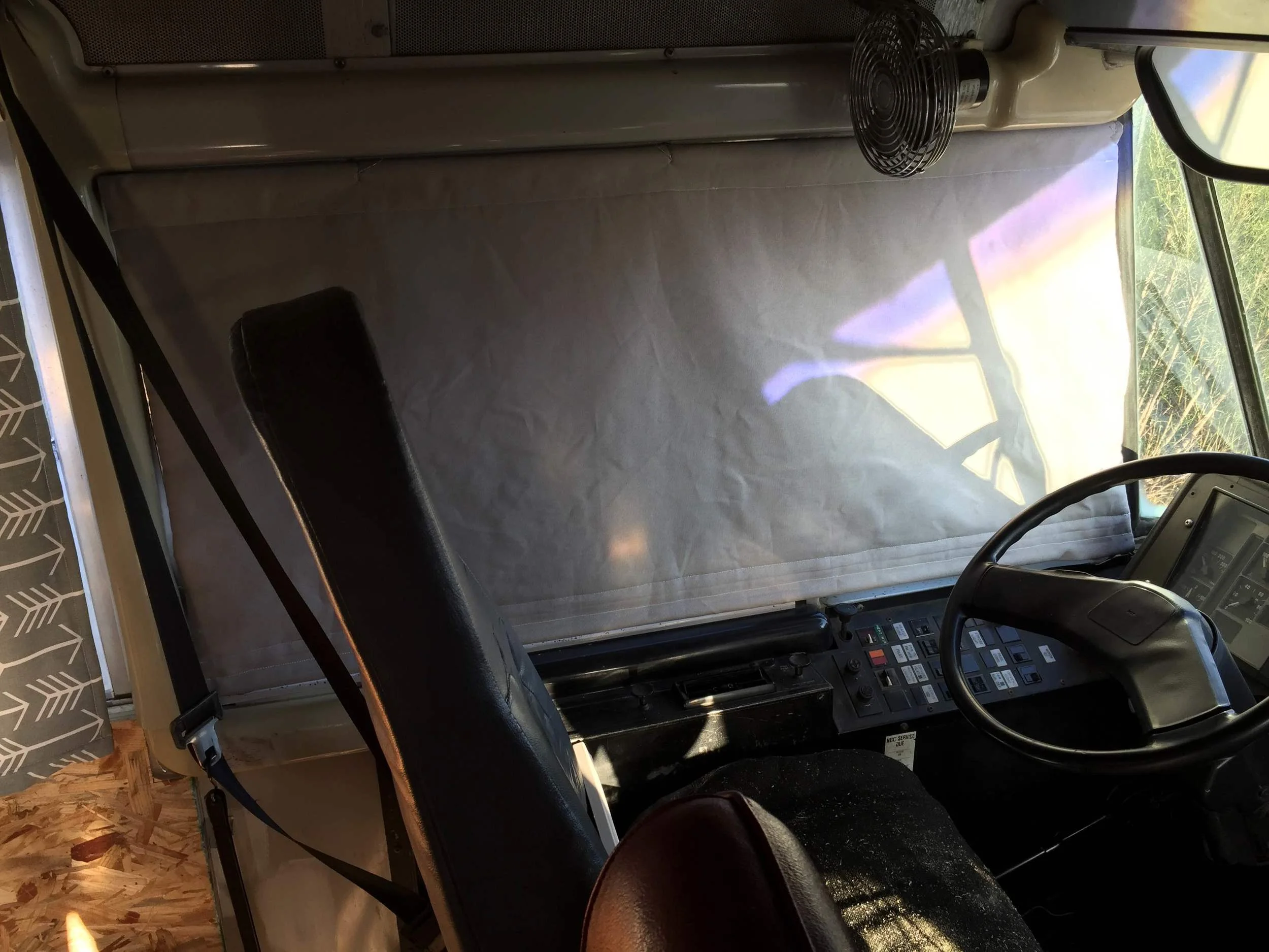 The curtain blocks every bit of light out and is easy to roll up with a dowel in the bottom.