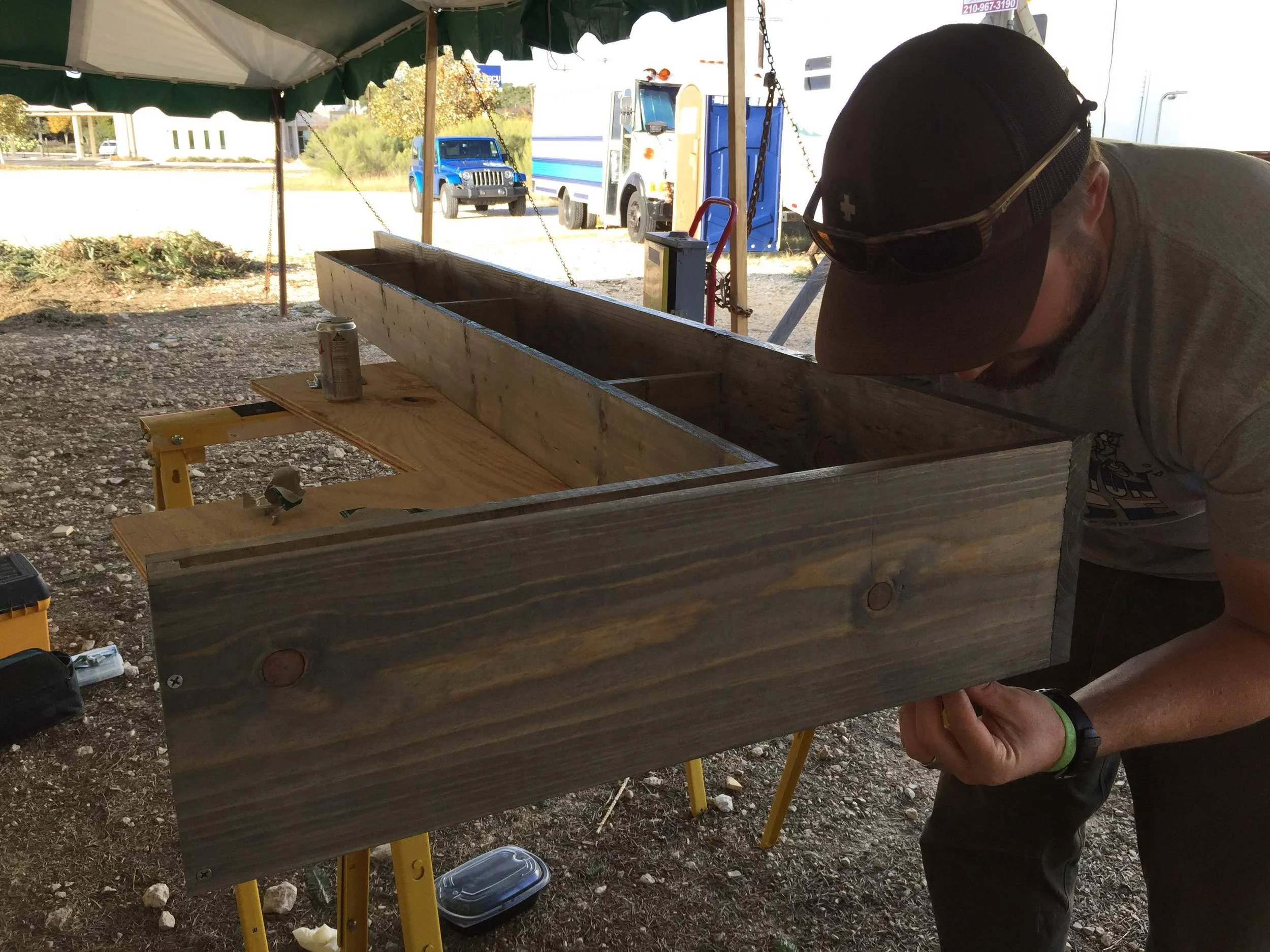 I did the staining, I promise! This is Christian attaching the "L" brackets to the cubby so we can attach it to the counter.