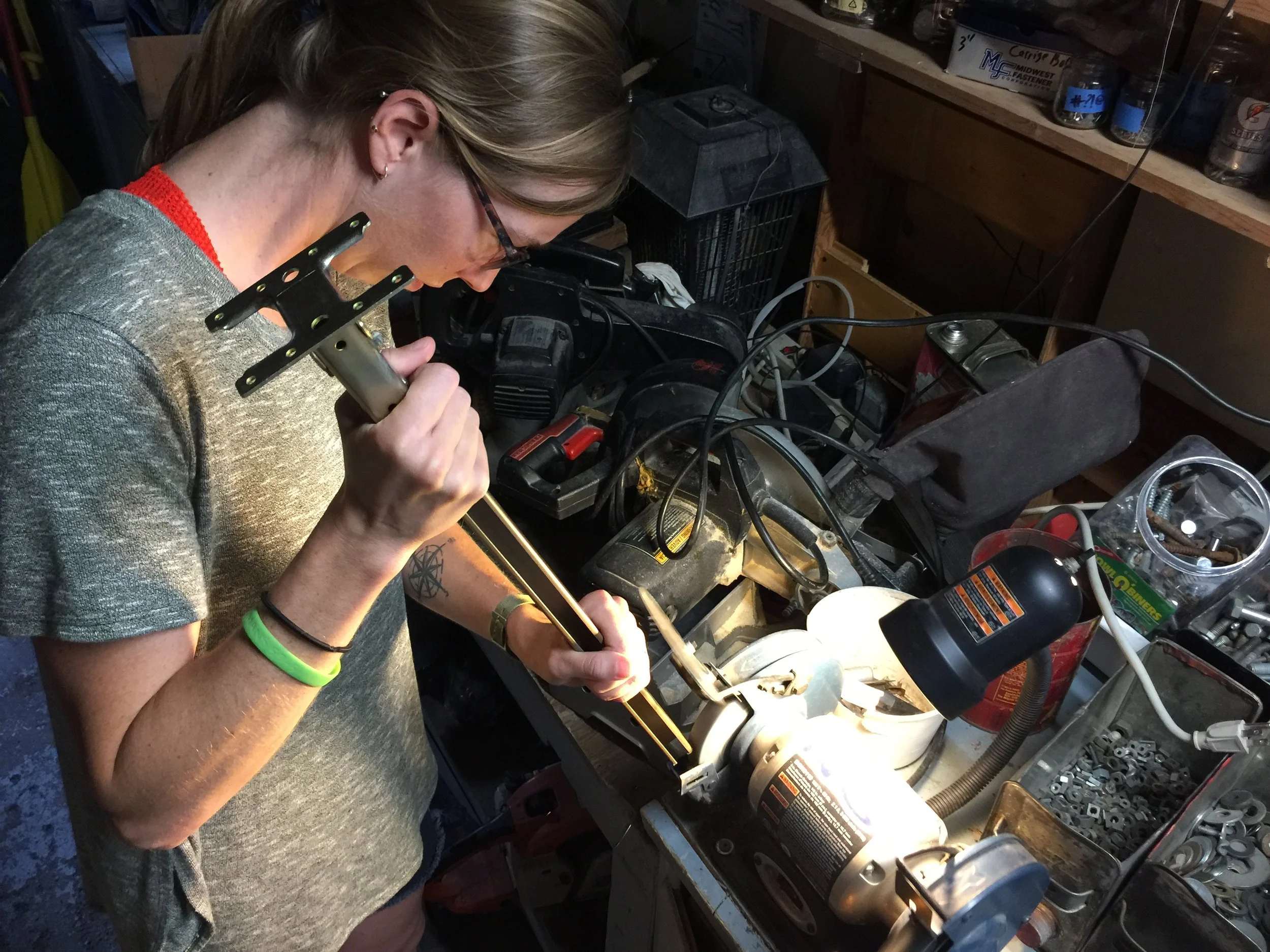 Chels grinding away, making custom bed legs. We had to cut them to size, and Chels reminded me often that, "Its easier to take away metal than it is to add it after its gone." Very true. Measure, measure, measure.