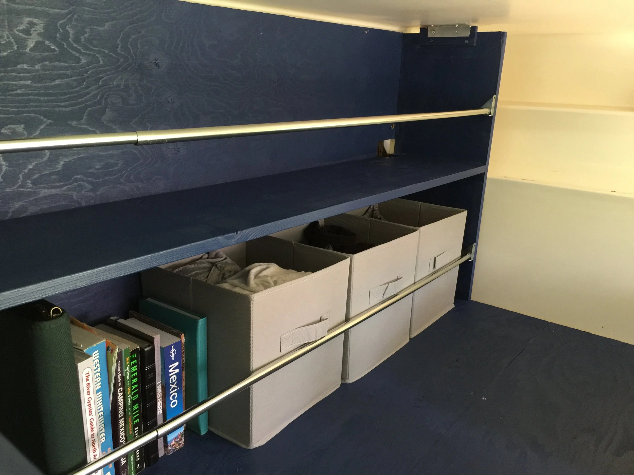 Super cheap tension-rod-and-brace storage solution. Remember kids, always rig to drive.