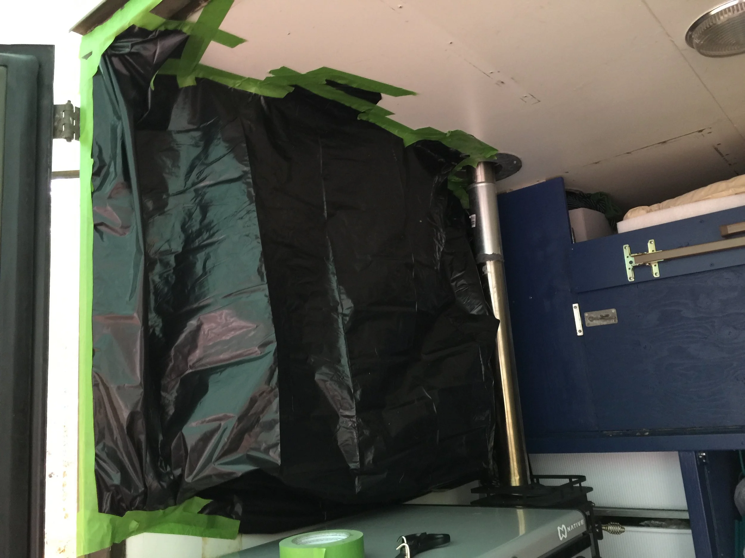 We taped a giant trash bag around the space for the window to contain the mess as we sawed into the side of the box. It worked extremely well.
