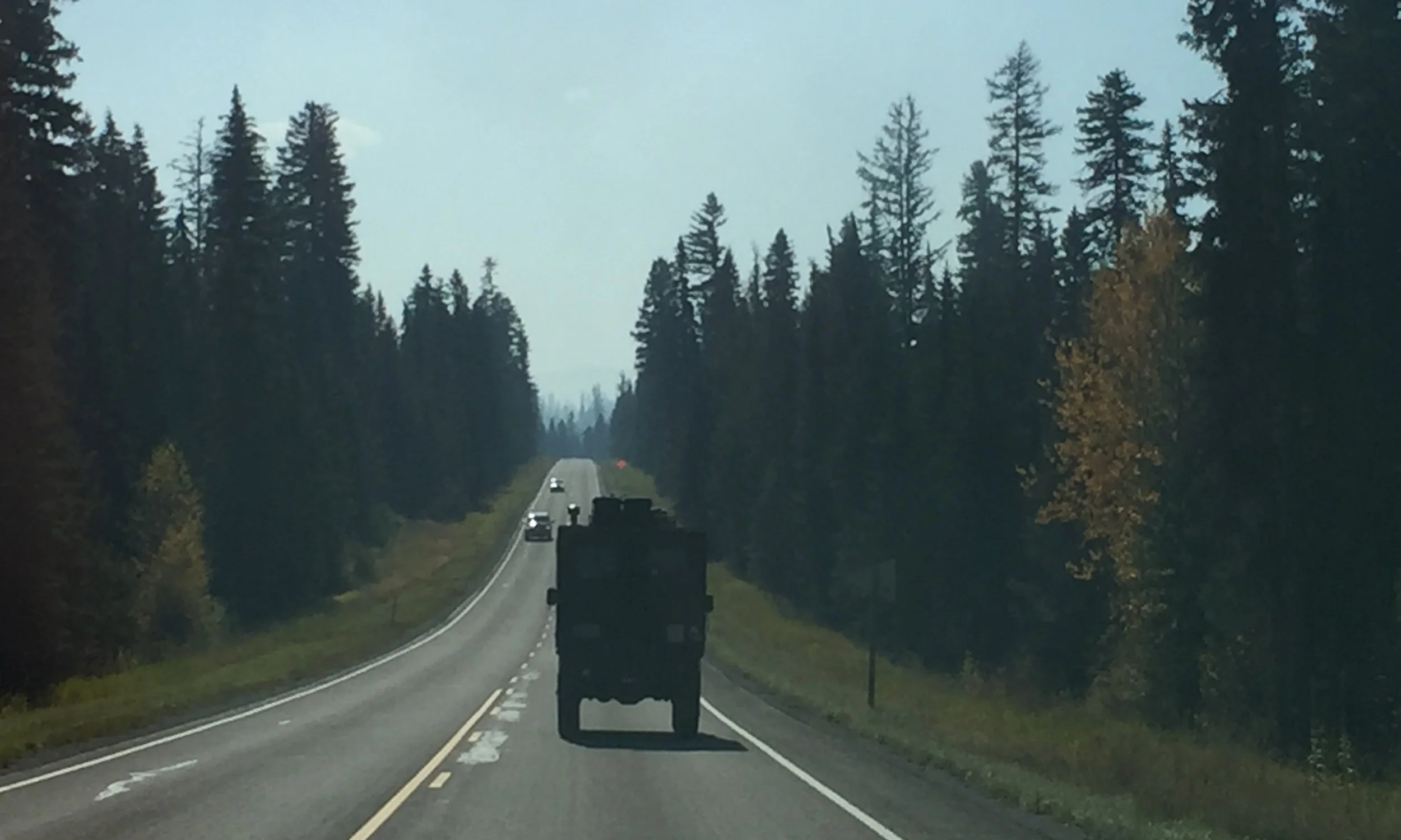 Rocketing along the Swan-Seeley highway with some evidence of controlled burns around us. The silhouette of the portal axels is profound.