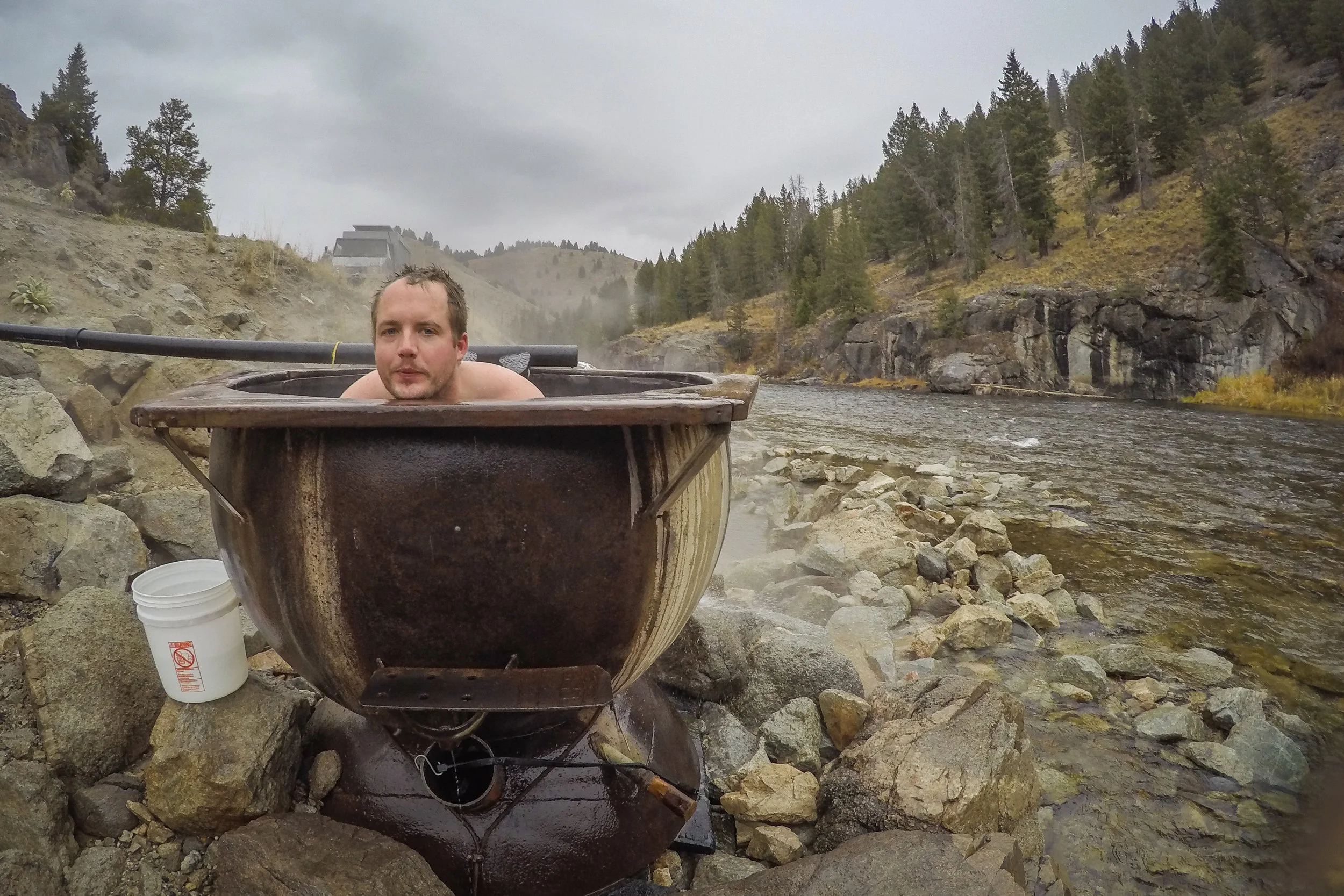 Being boiled and steamed like a human sized crawdad! I think there is a small rivulet of hot-springs water that flows under the cauldron and keeps the water warm even when the black pipe isn't feeding the tub.