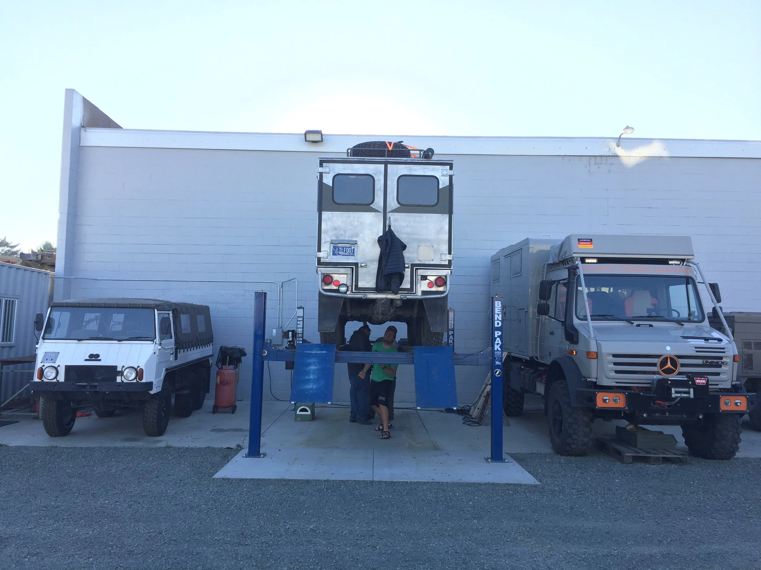 Little Foot on the lift, next to a 712M to the left and a really expensive Unimog to the right.