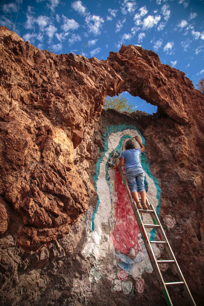 The cliff created a fantastic halo around the mural's head. The last coat of paint had been weakened by the most recent hurricane.