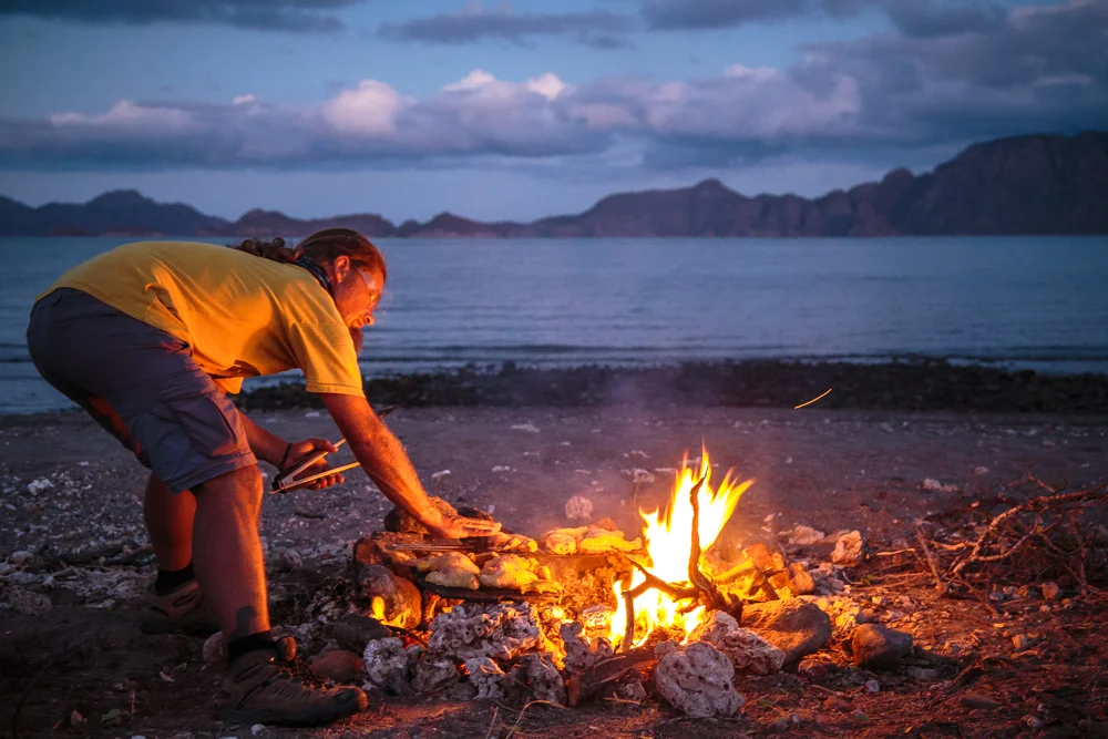Pablo tending and respecting the fire.