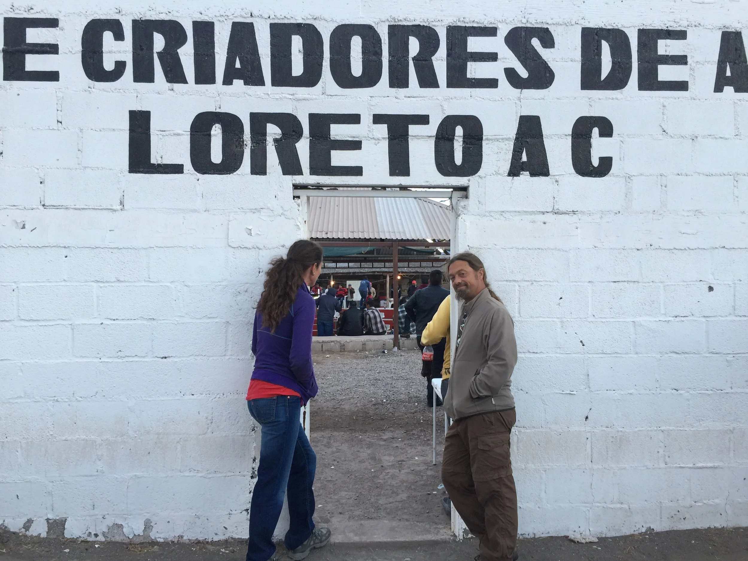 Pablo and Anna at the enterance to the cock fight arena - Pablo is smiling because he knows we are all going in, and we are all going to love it.