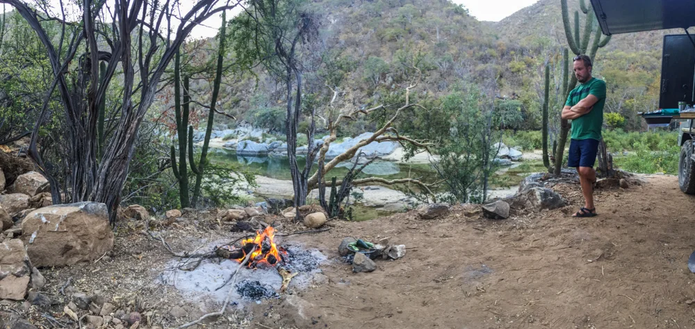 Preparing a campfire to cook steak and veggies.