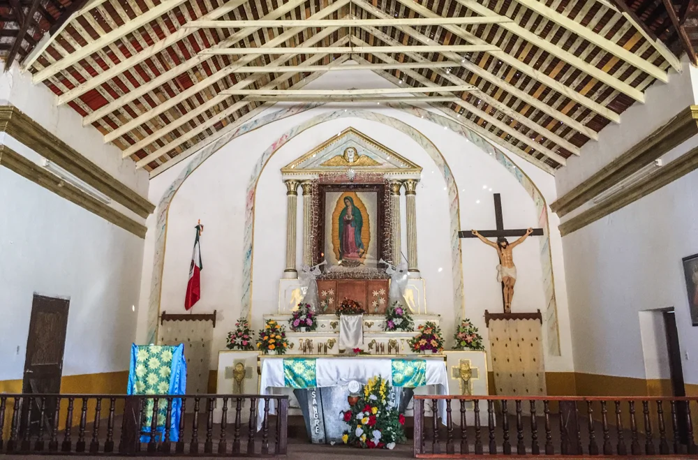 Inside the mission at El Triunfo, holes in the roof let speckled sunlight in.